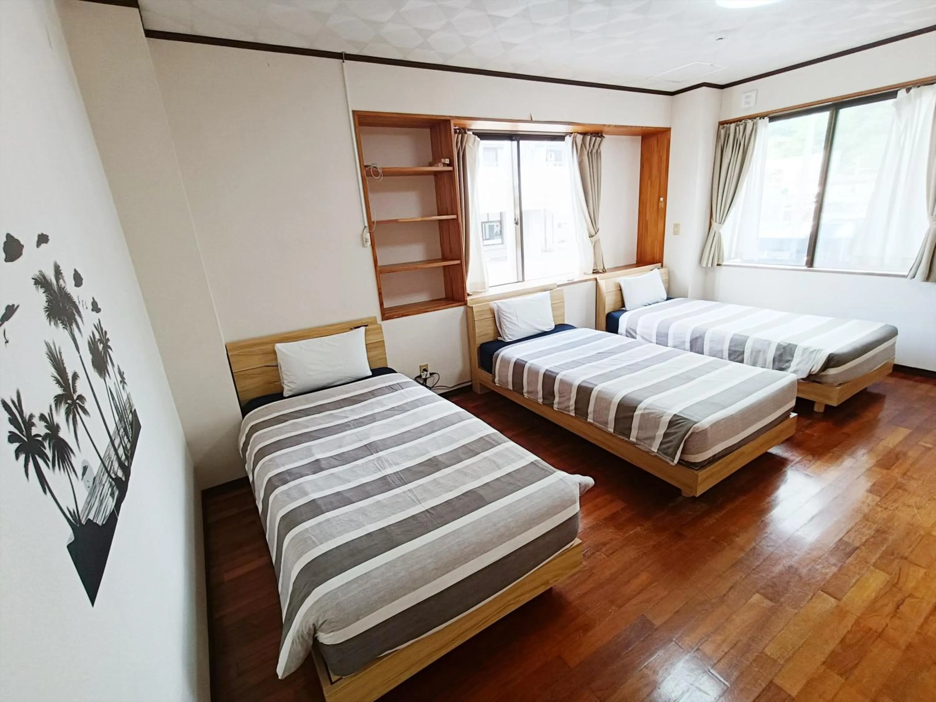 Bed in Kariyushi Condominium Resort Sea Side House