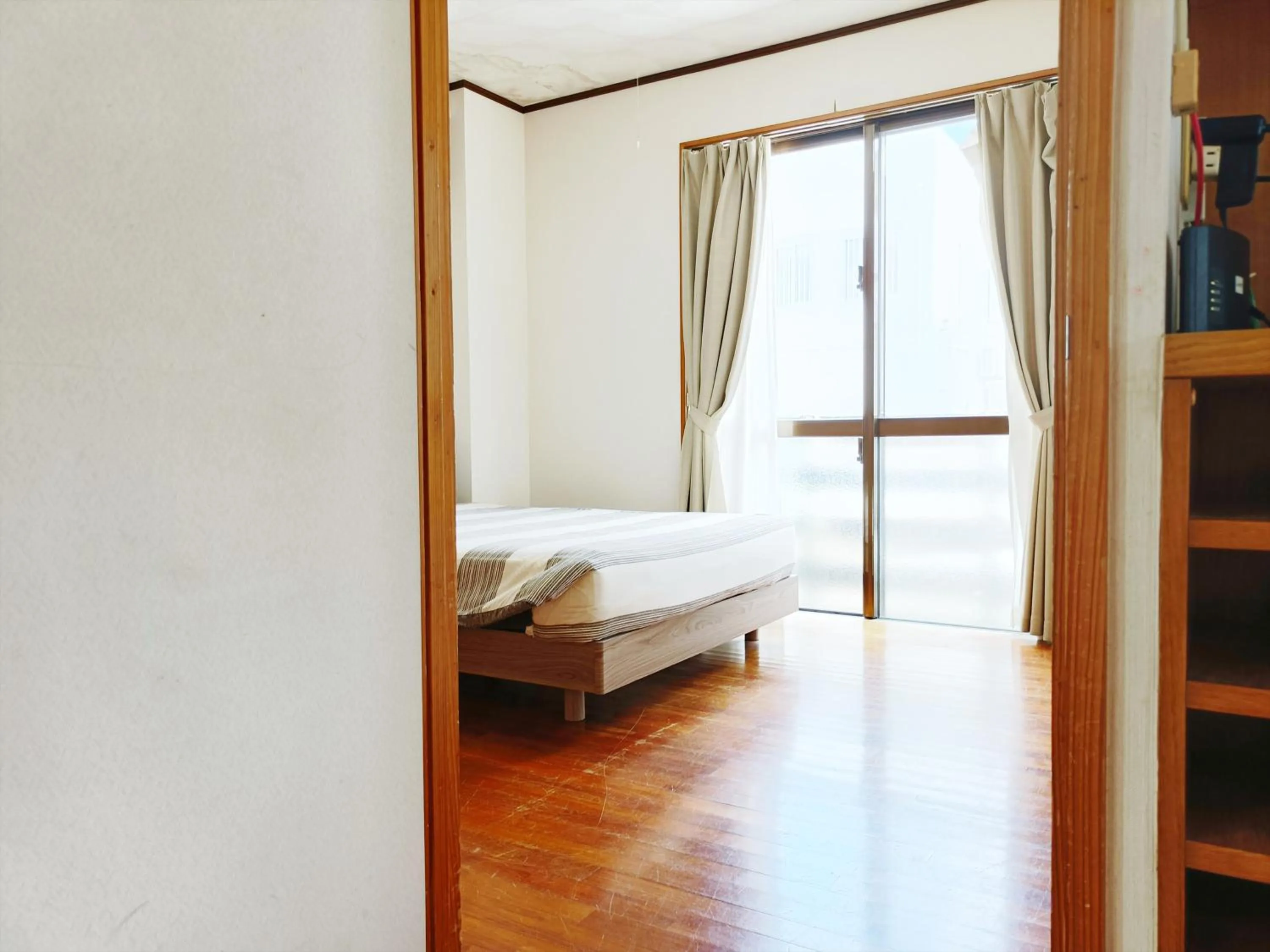 Bed in Kariyushi Condominium Resort Sea Side House