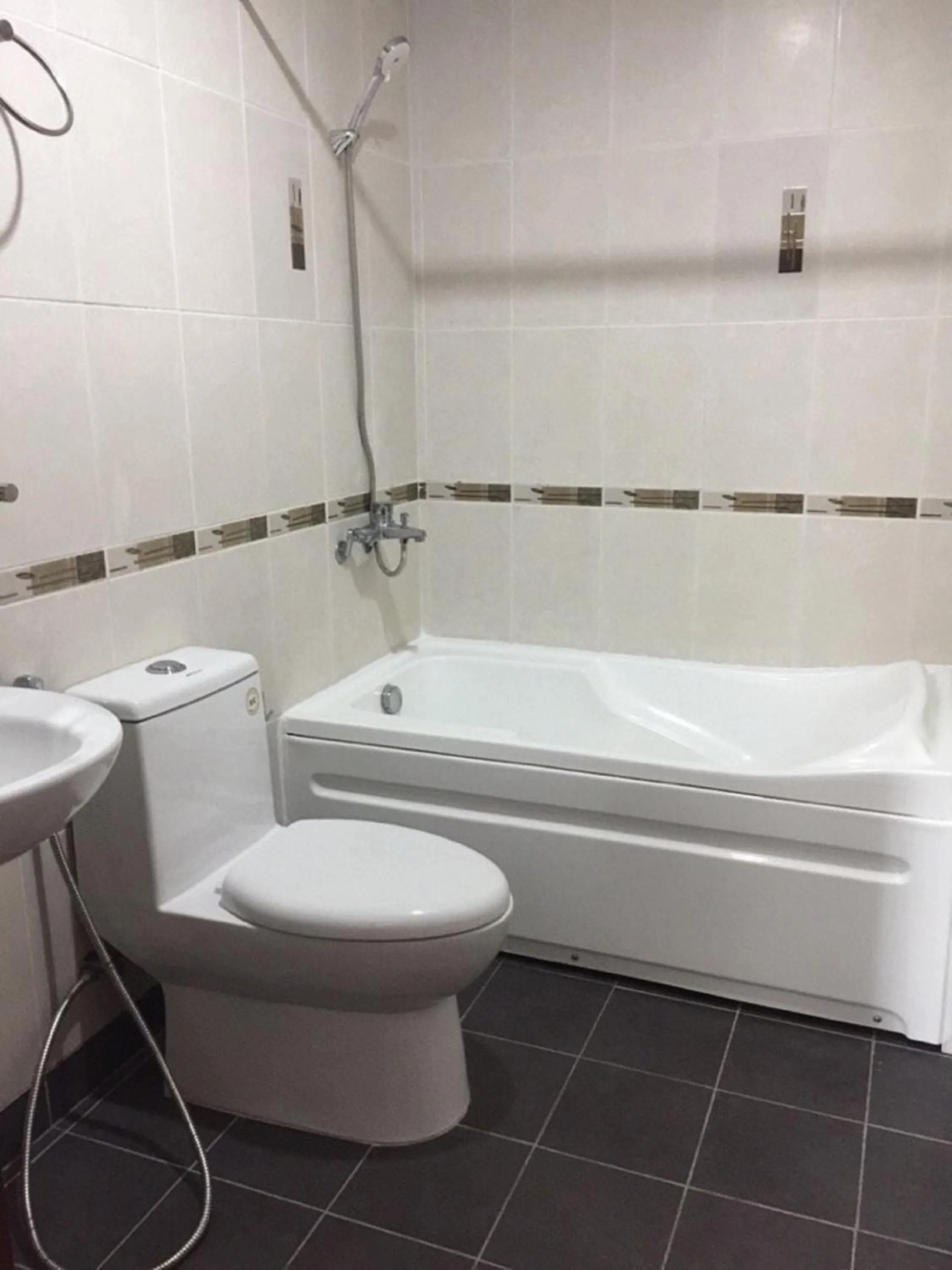 Bathroom in Chillax Apartment - Cozy 3-Bedroom City View Home at Tower, District 1