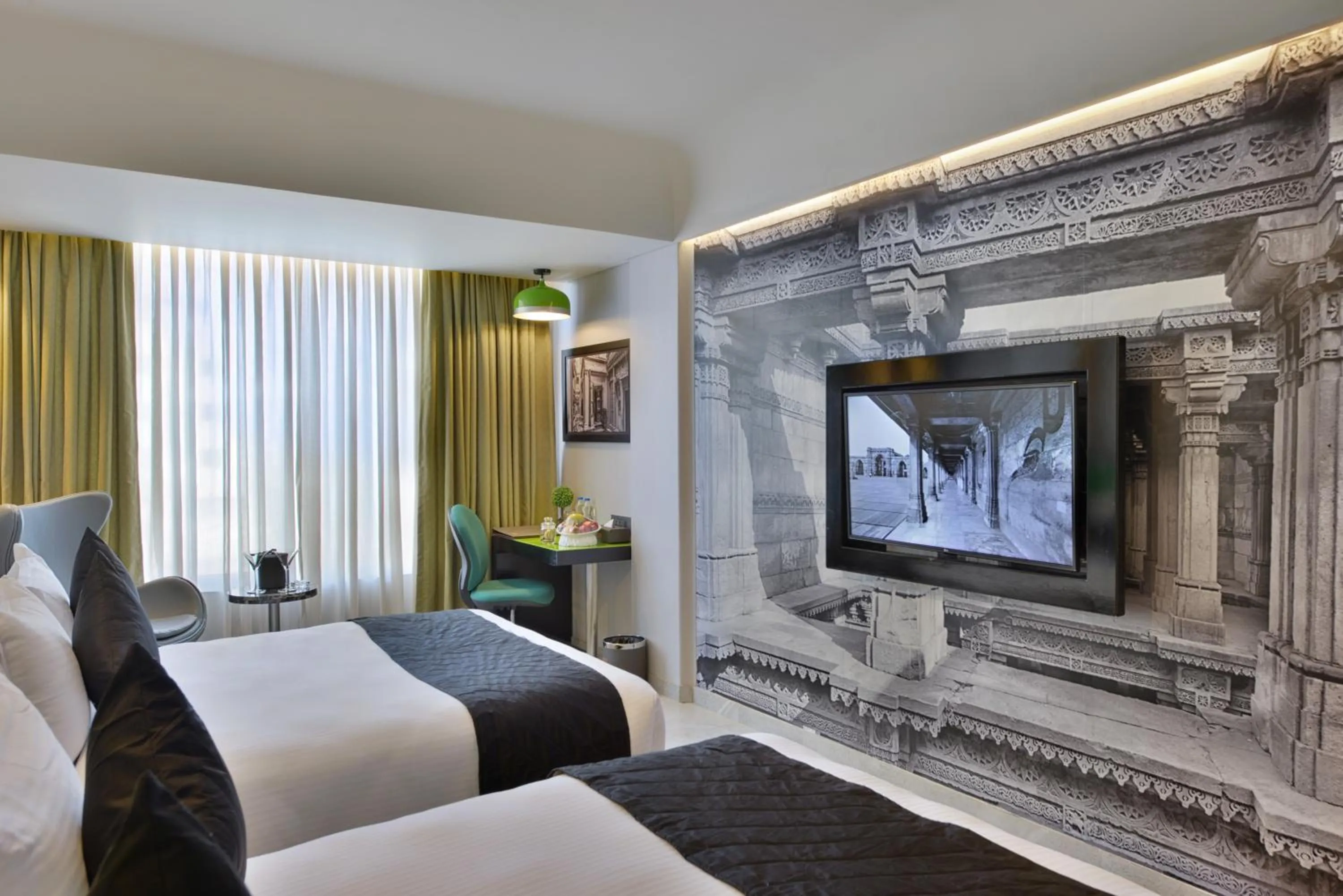 Communal lounge/ TV room, Bed in Regenta Central Antarim Ahmedabad