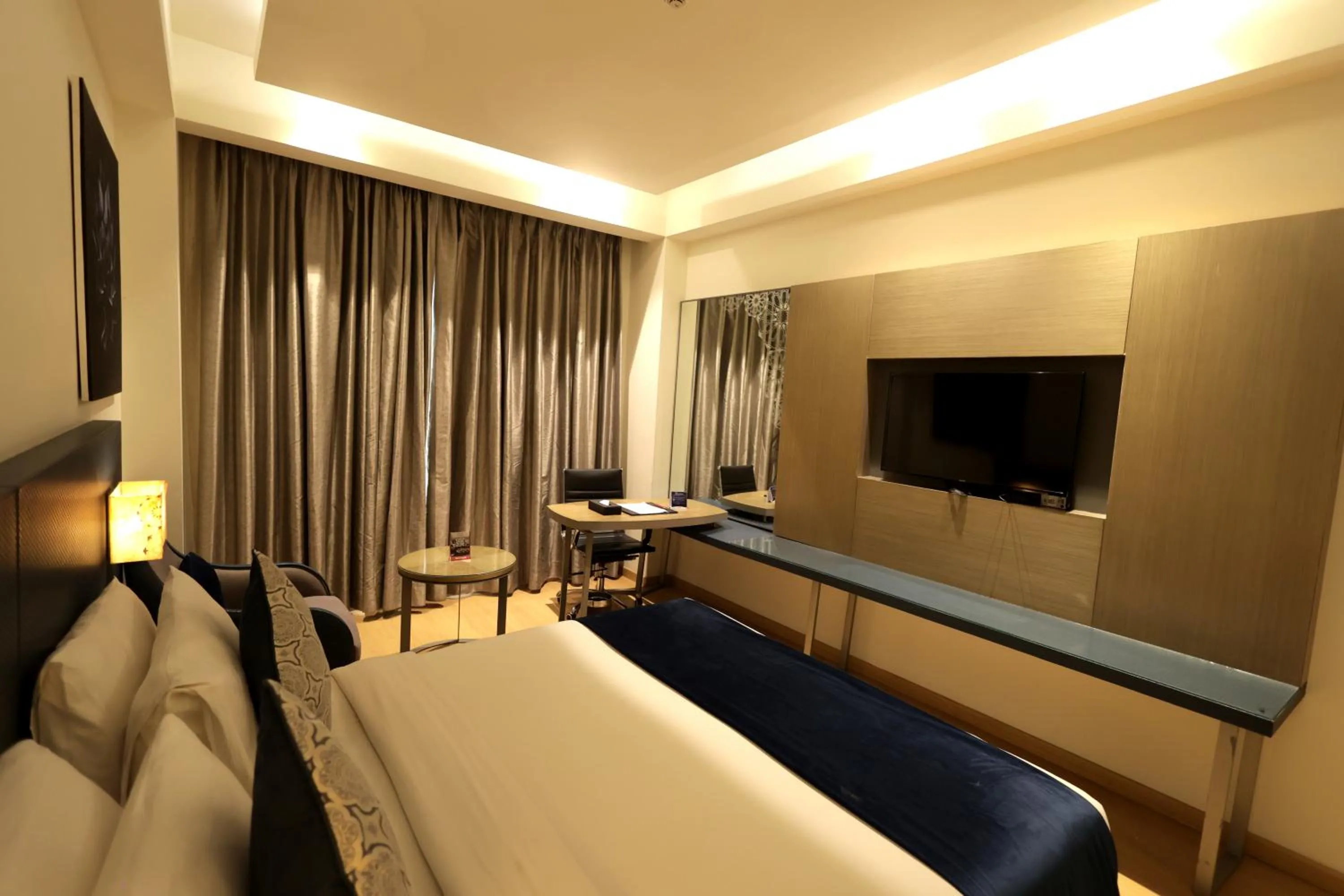 Bed in Ramada by Wyndham Lucknow Hotel and Convention Center