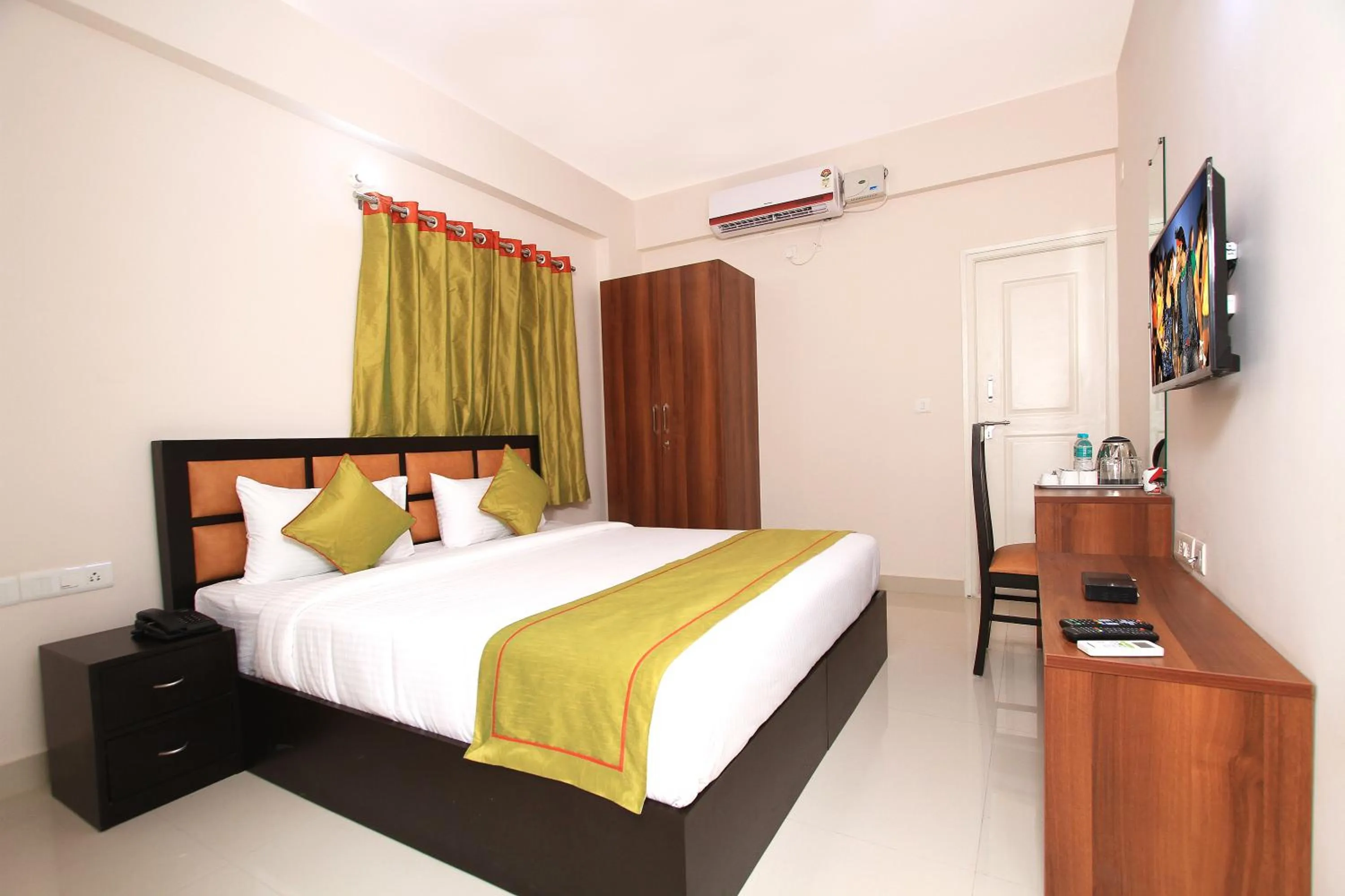 Bed in Arra Grande Suites Bangalore airport hotel
