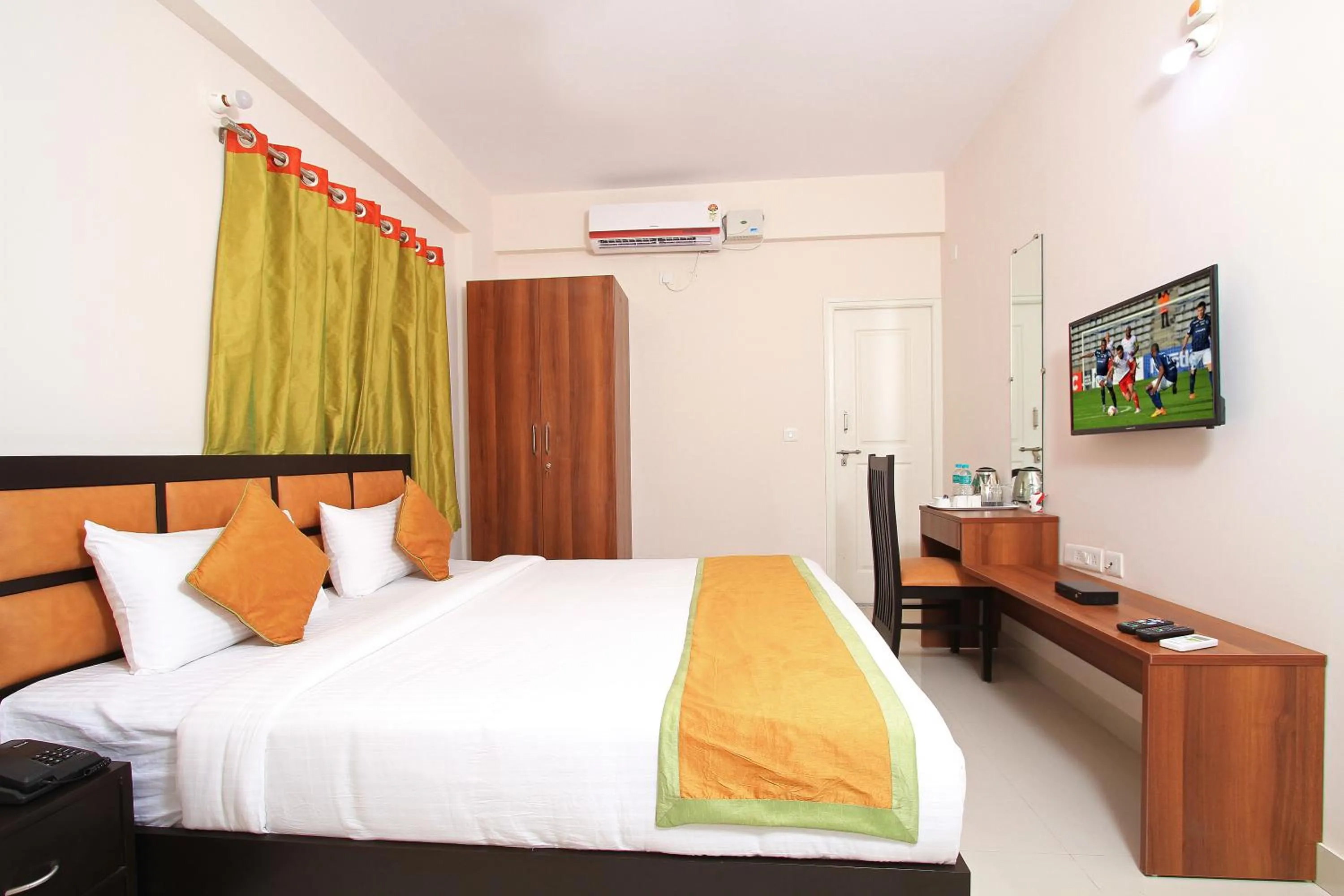 Bed in Arra Grande Suites Bangalore airport hotel