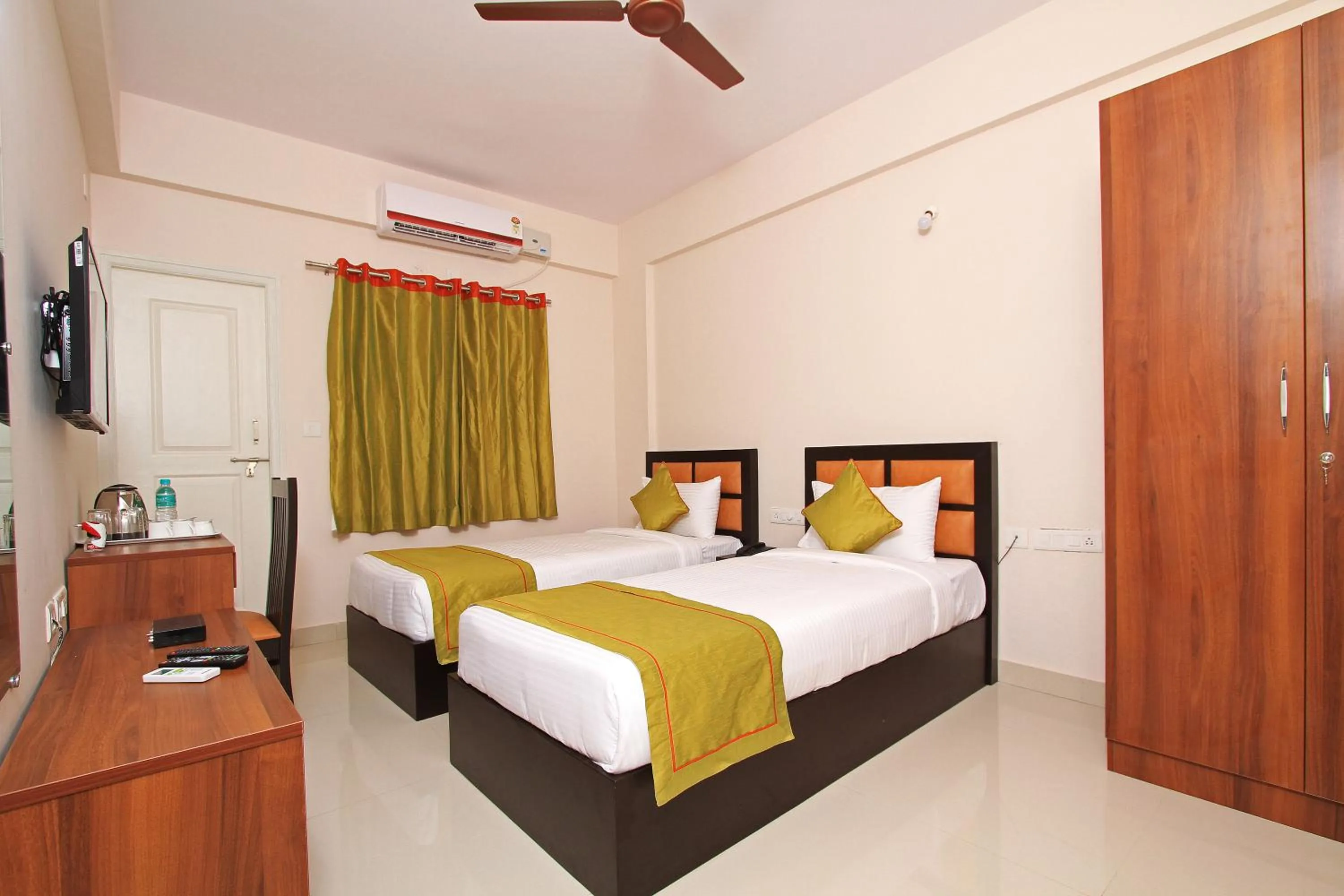 Bed in Arra Grande Suites Bangalore airport hotel