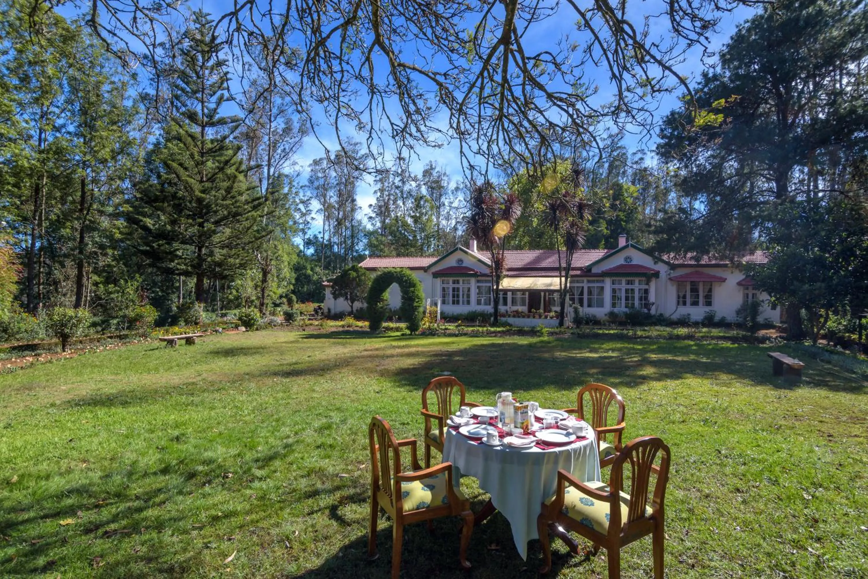 Property building in SaffronStays Milton Abbott Estate - 2BR colonial-era bungalow with garden, golf course views & bonfire nights near Ooty Golf Club