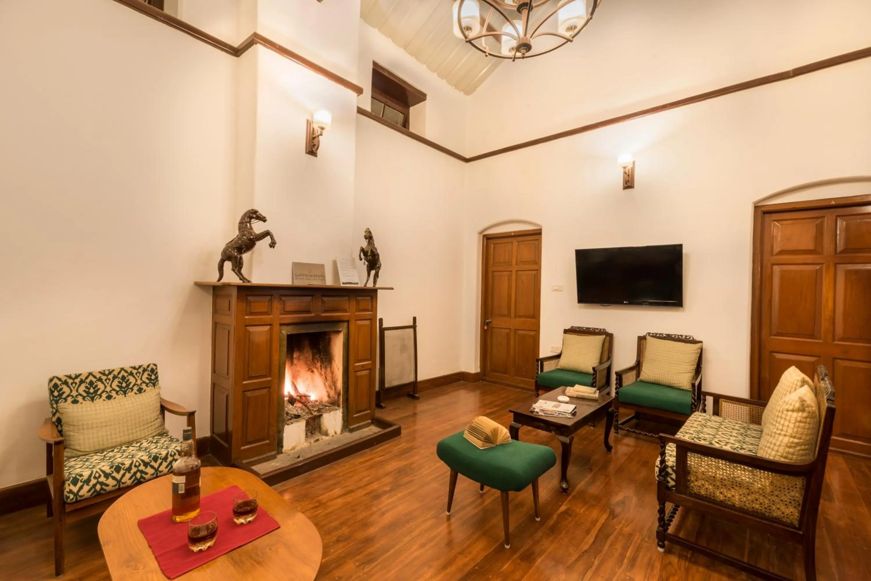 Communal lounge/ TV room in SaffronStays Milton Abbott Estate - 2BR colonial-era bungalow with garden, golf course views & bonfire nights near Ooty Golf Club