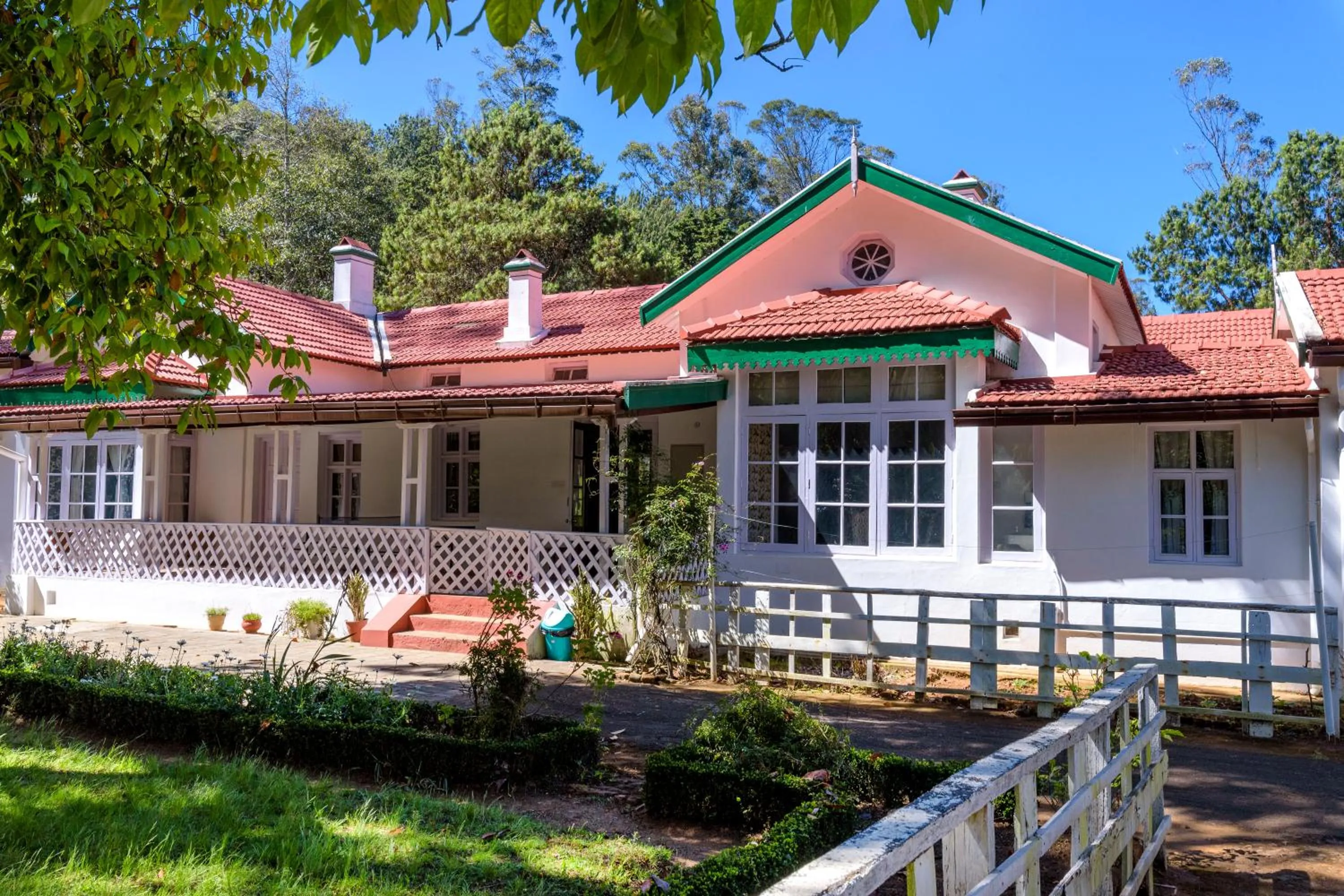 Property building in SaffronStays Milton Abbott Estate - 2BR colonial-era bungalow with garden, golf course views & bonfire nights near Ooty Golf Club