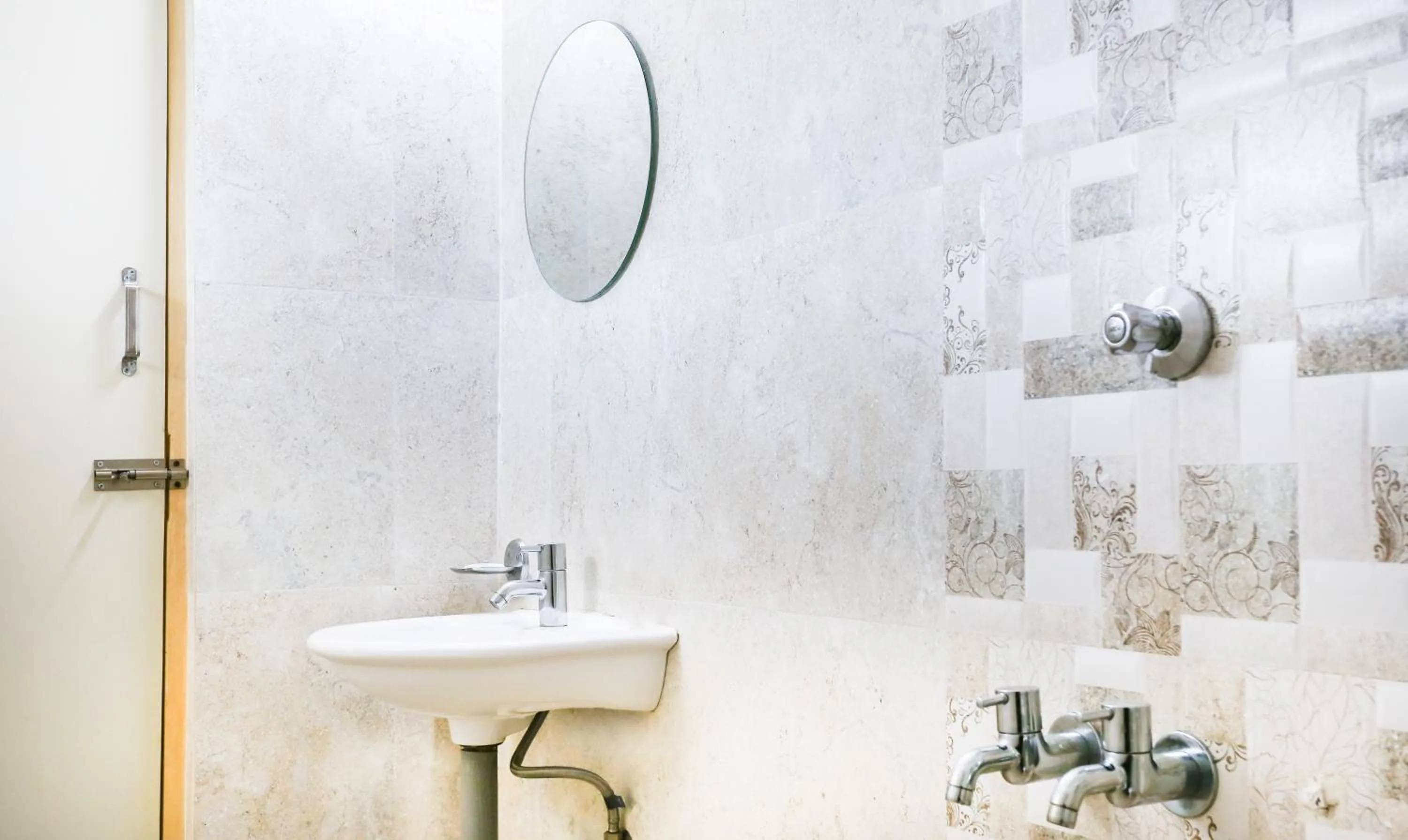 Bathroom in Treebo Comforts Inn, University Road Deralakatte