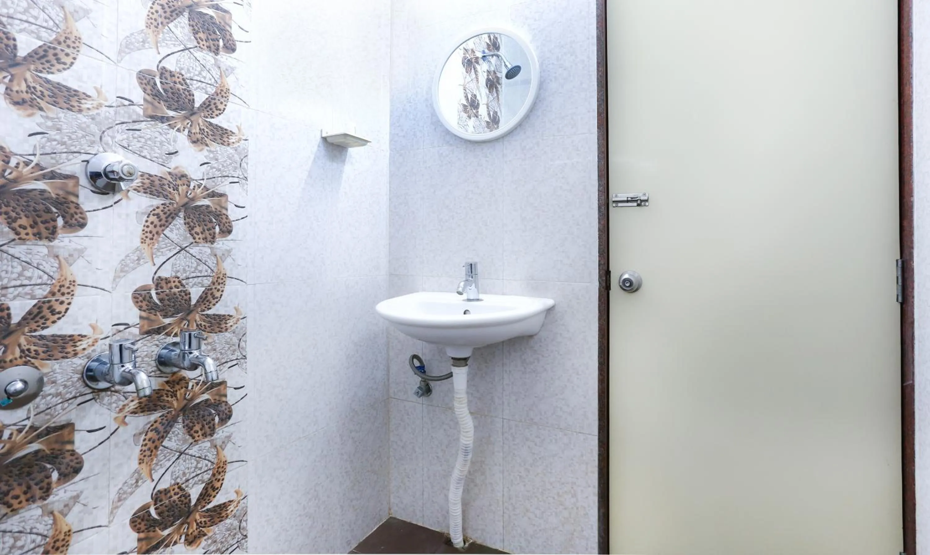 Bathroom in Treebo Comforts Inn, University Road Deralakatte