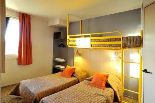 Bed in Welcomotel Limoges