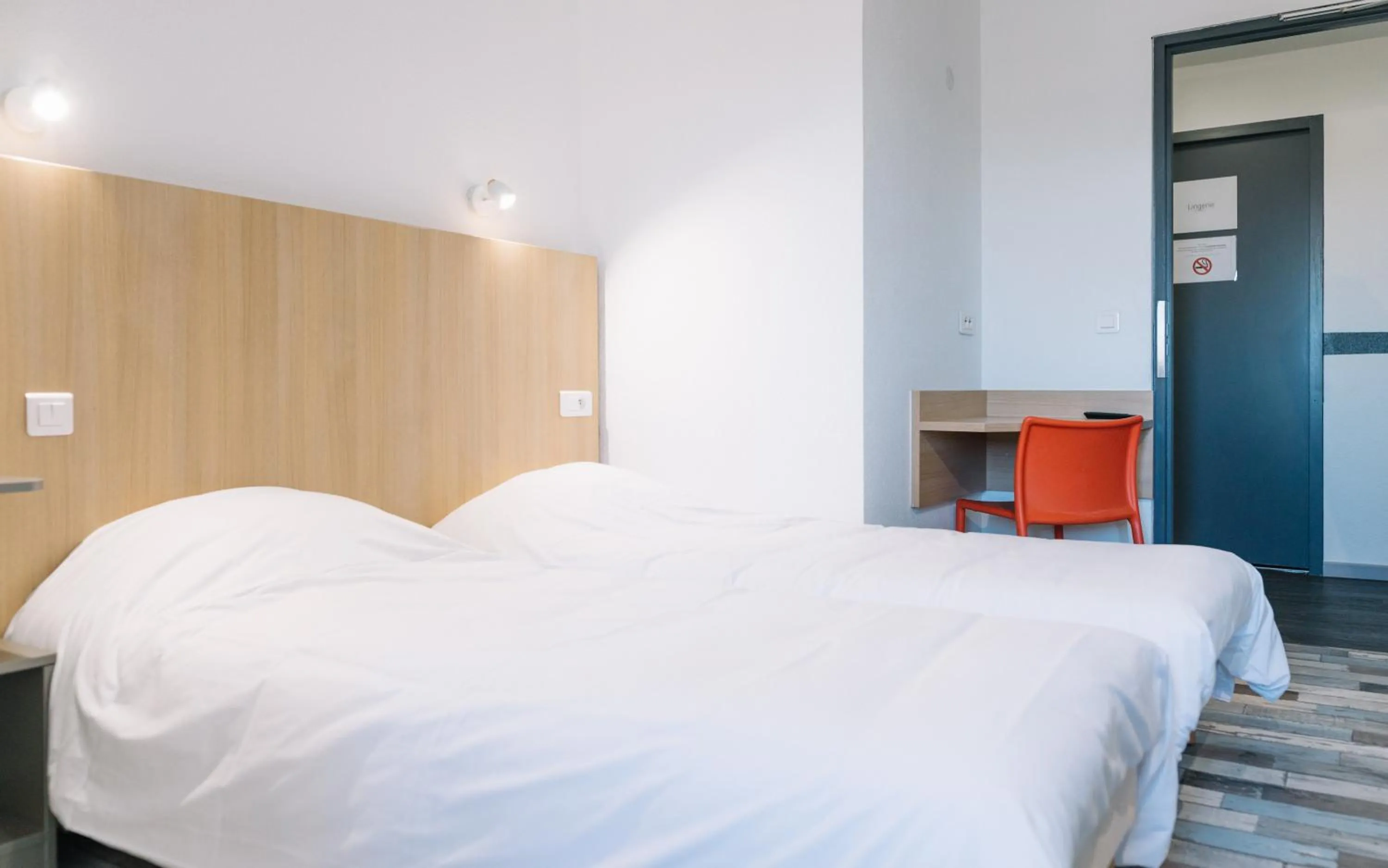 Bed in Welcomotel Limoges