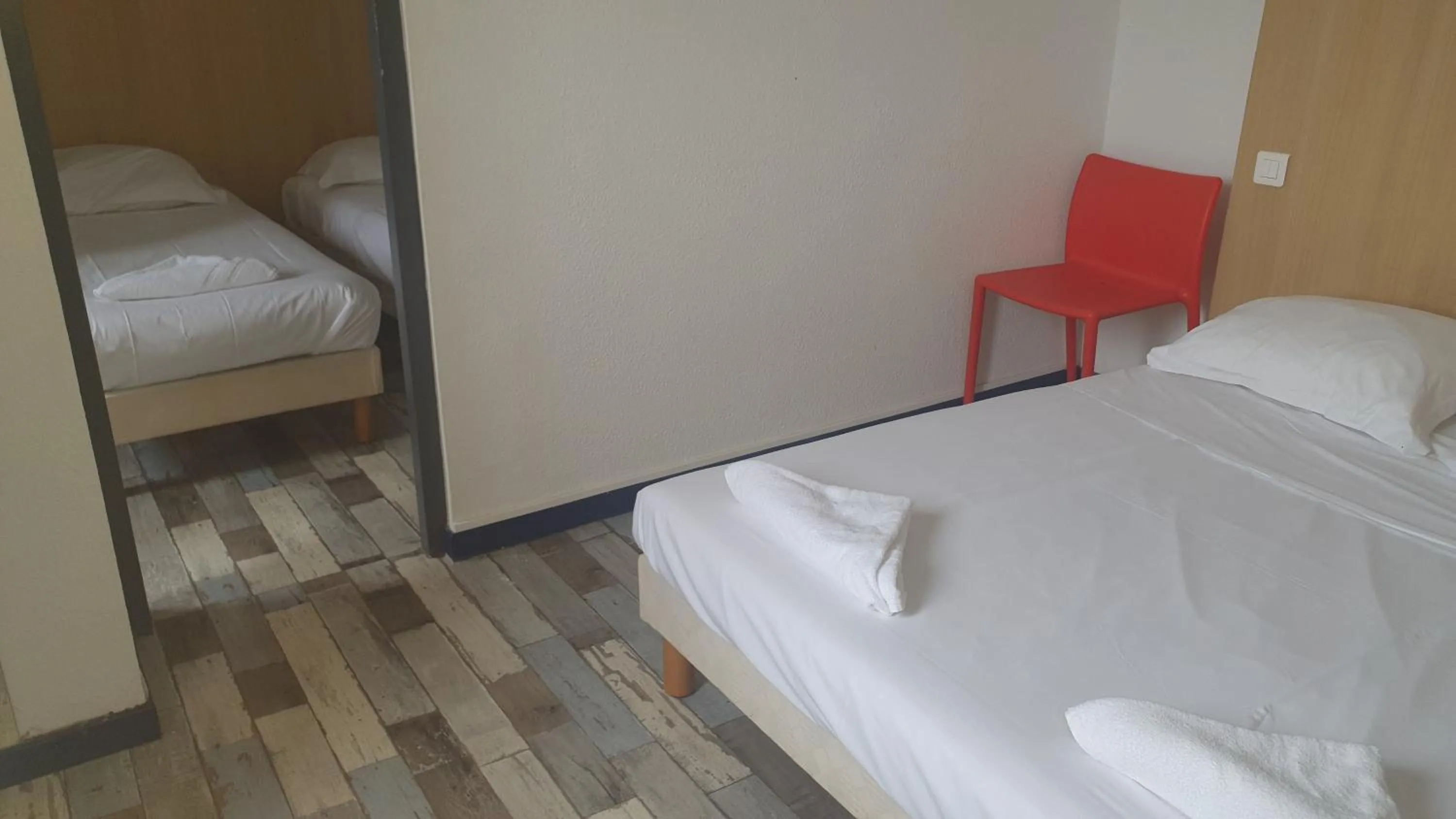 Bed in Welcomotel Limoges