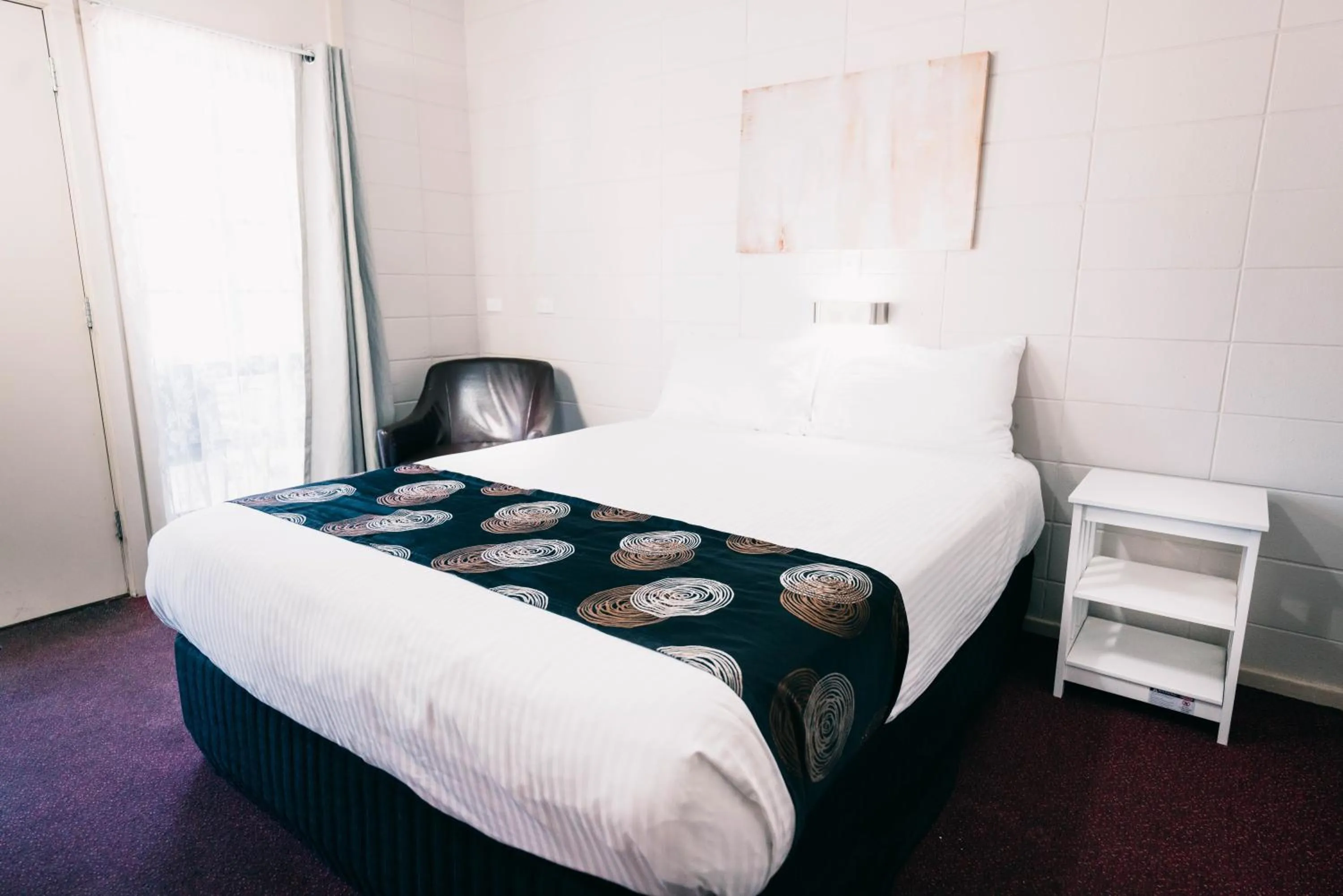 Bed in Motel Poinsettia