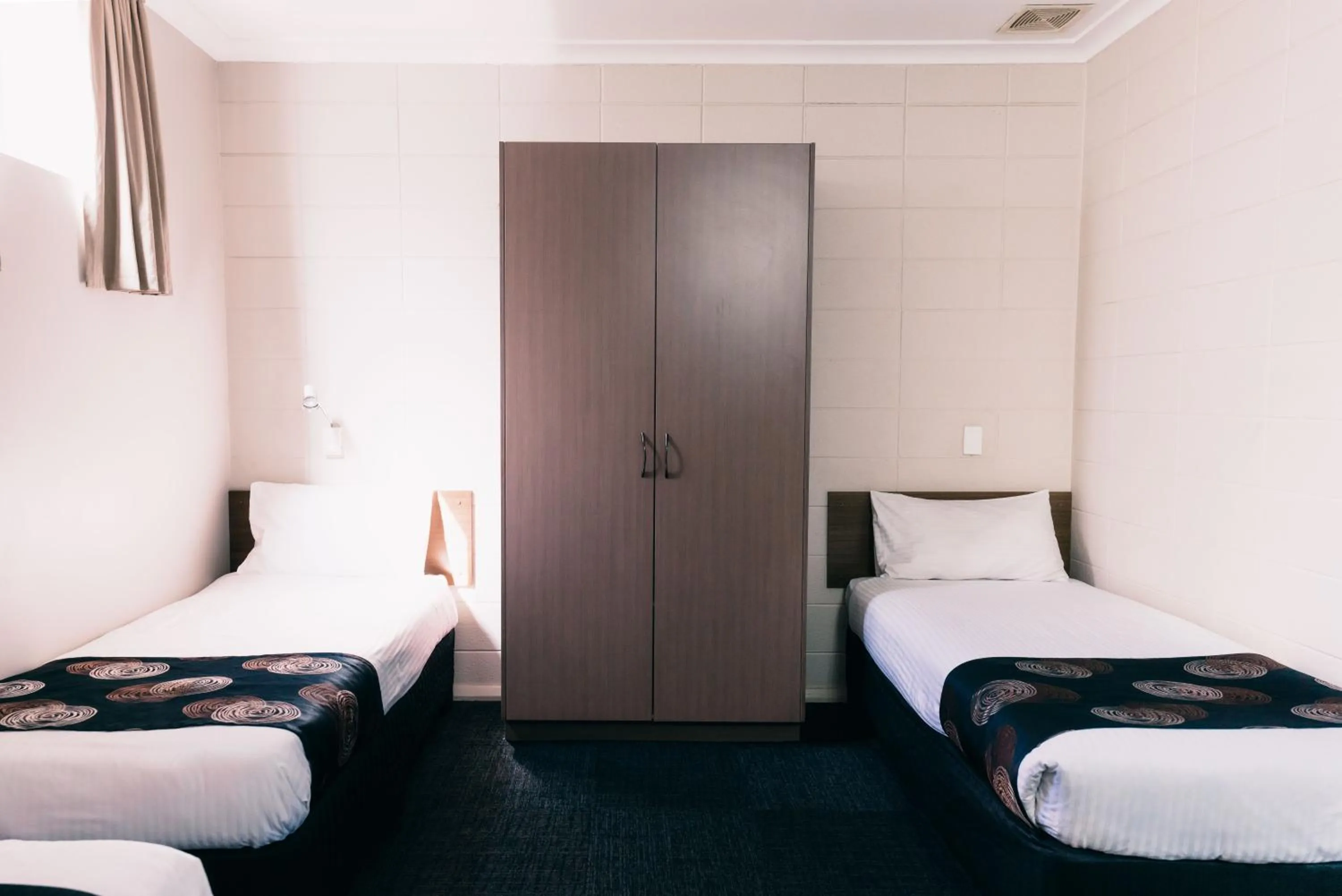 Bed in Motel Poinsettia