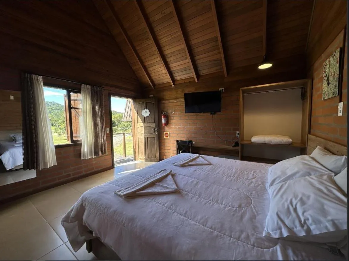 Bed in Pousada Casarão Gastehaus