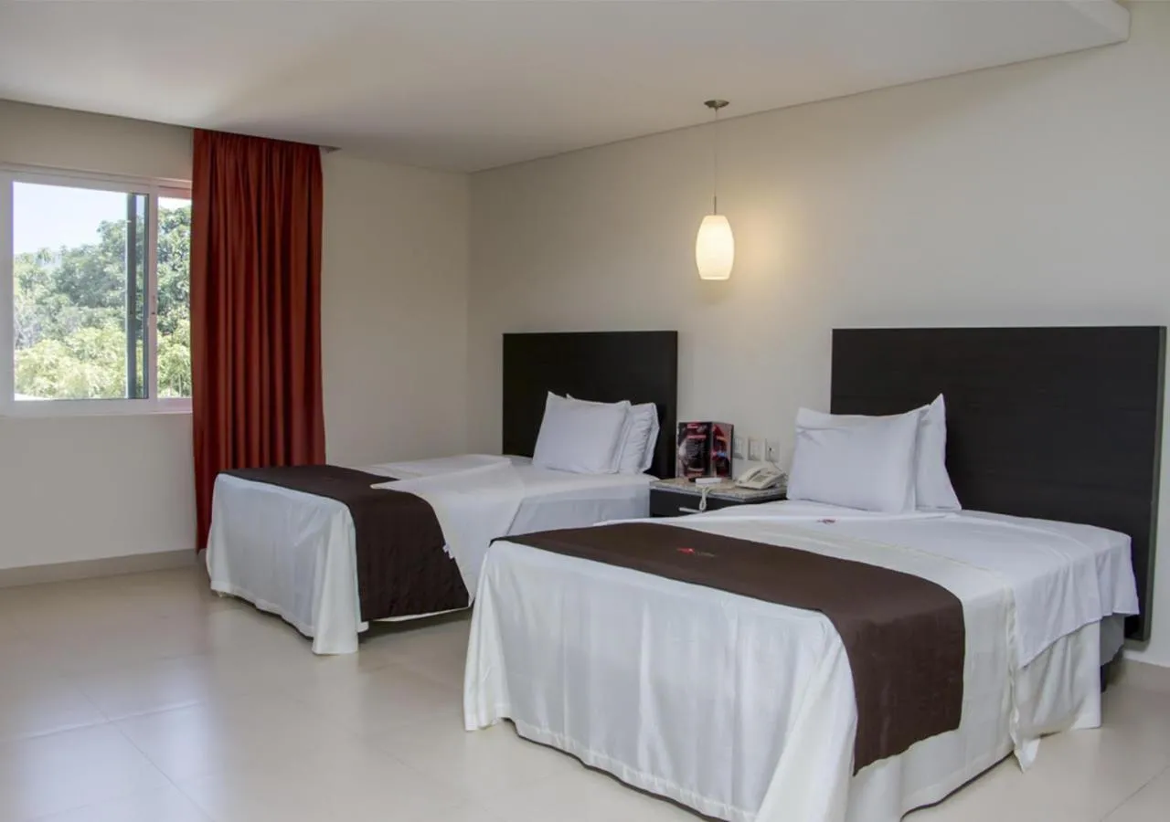 Bed in La Isla Auto Hotel