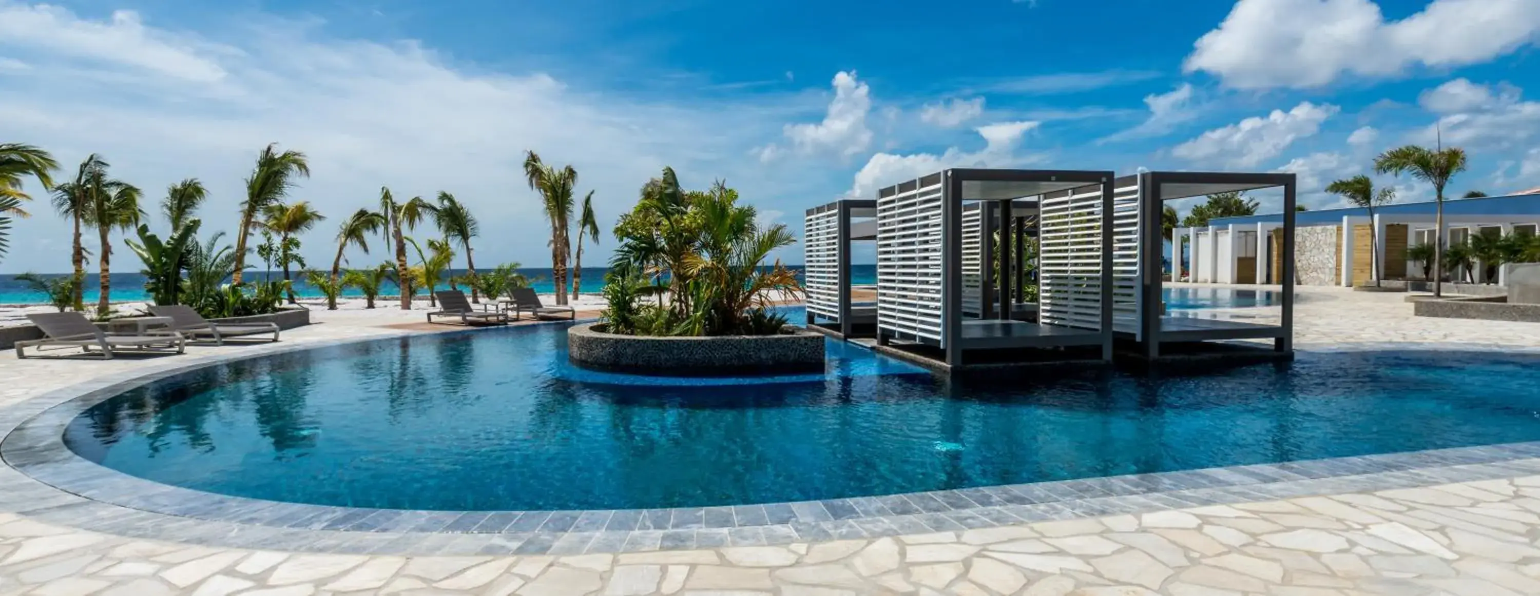 Swimming pool in Delfins Beach Resort Bonaire, Tapestry Collection by Hilton Swimming pool in Delfins Beach Resort Bonaire, Tapestry Collection by Hilton