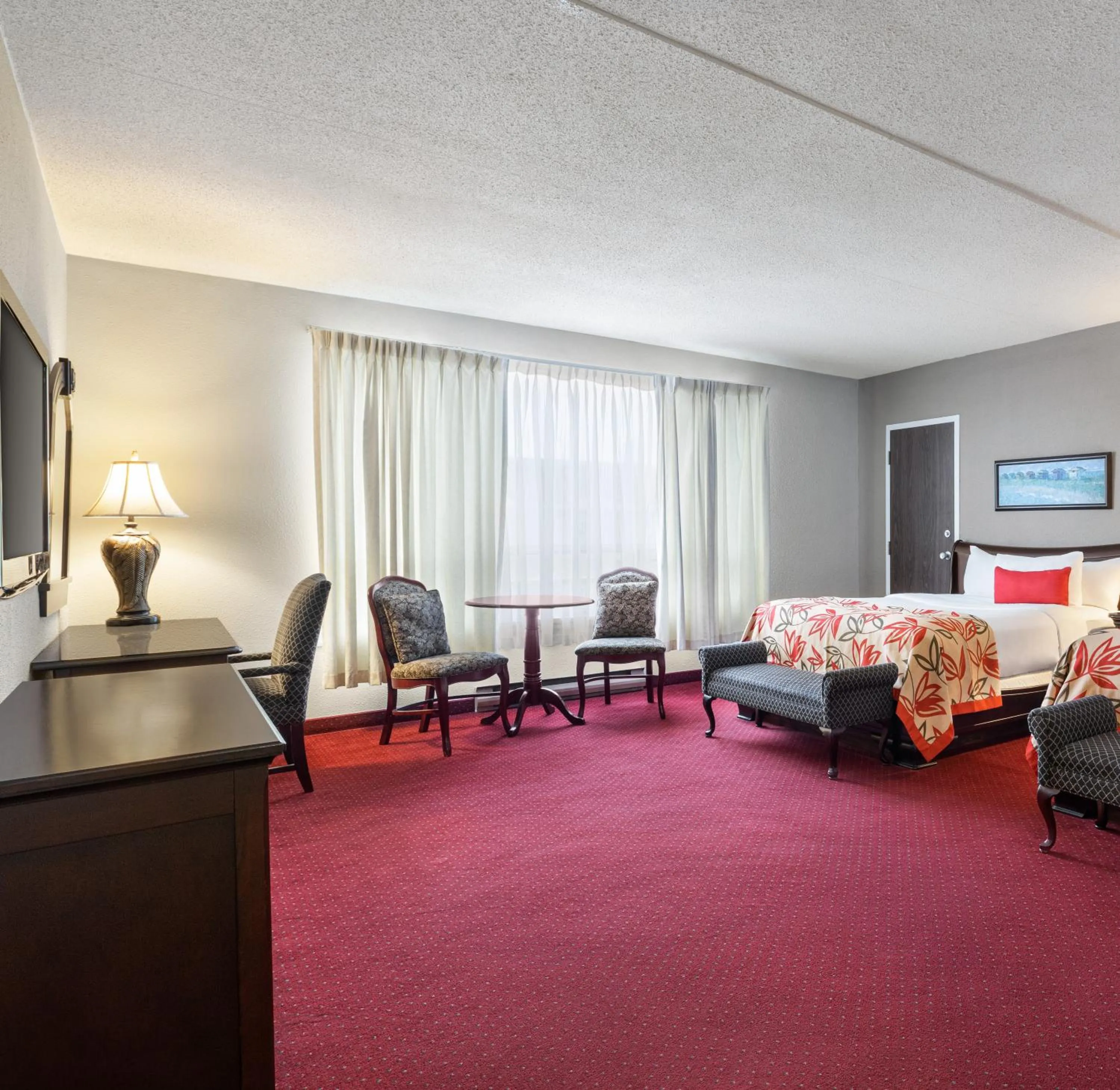 Seating area, Bed in Ramada by Wyndham Fredericton