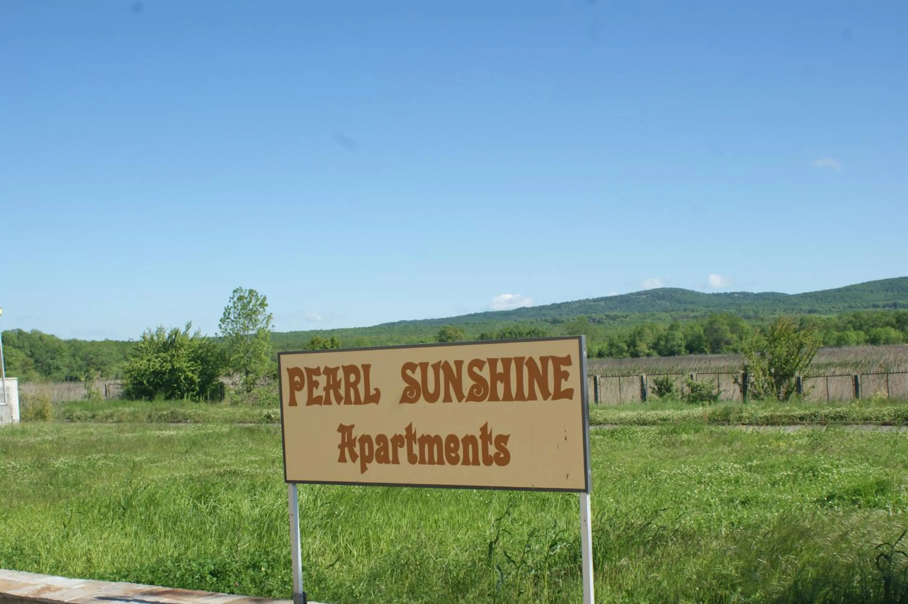 Property logo or sign in Pearl Sunshine Appartments