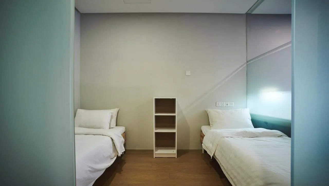 Bed in 188 Suites by NamaStay