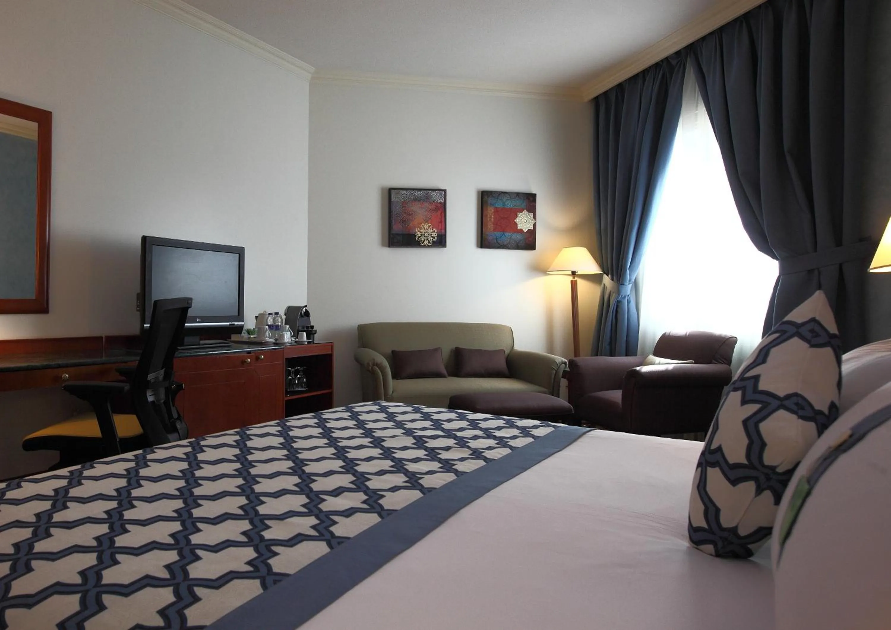 Seating area, Bed in Holiday Inn Al Khobar by IHG