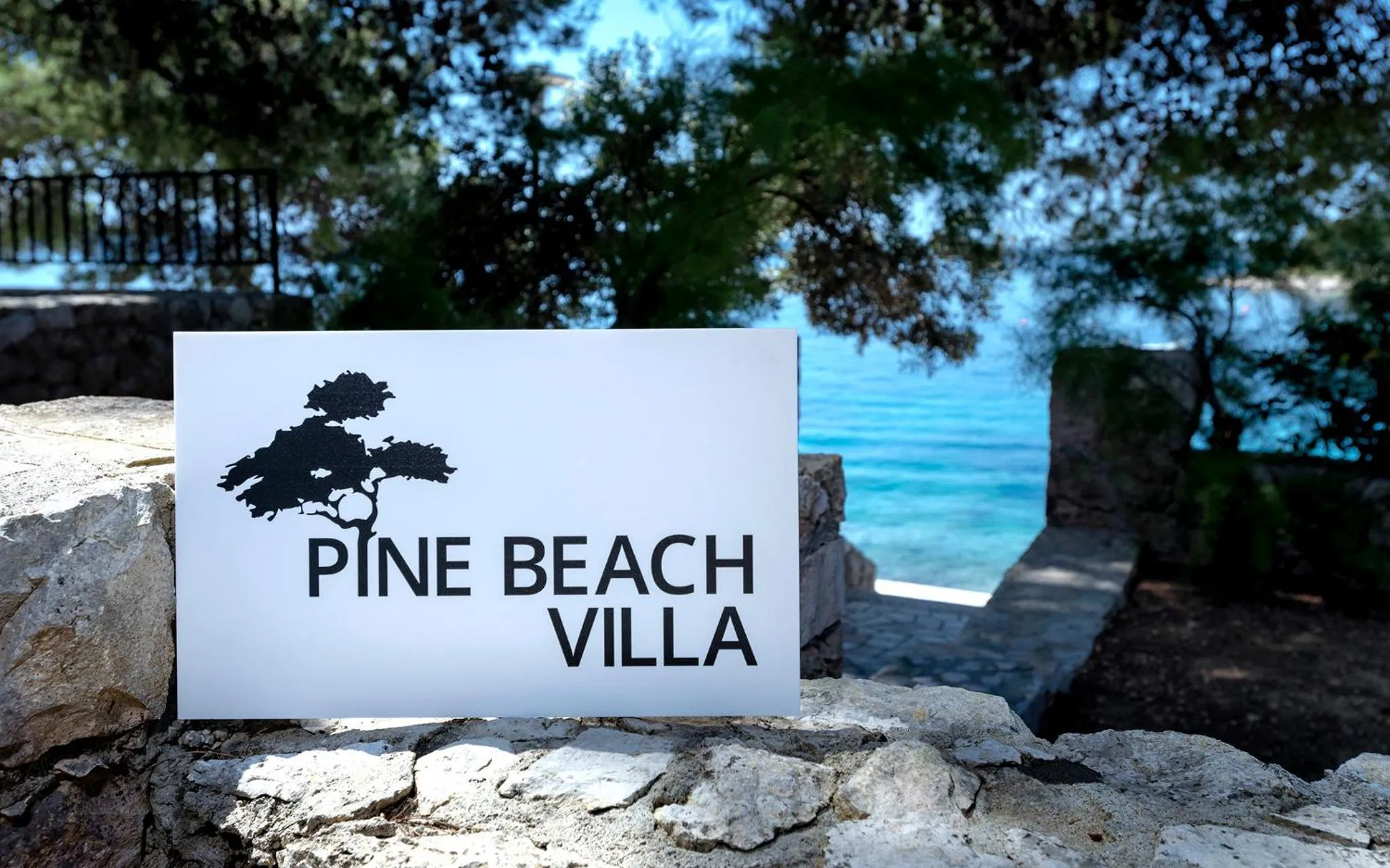 Property logo or sign in Pine Beach Villa