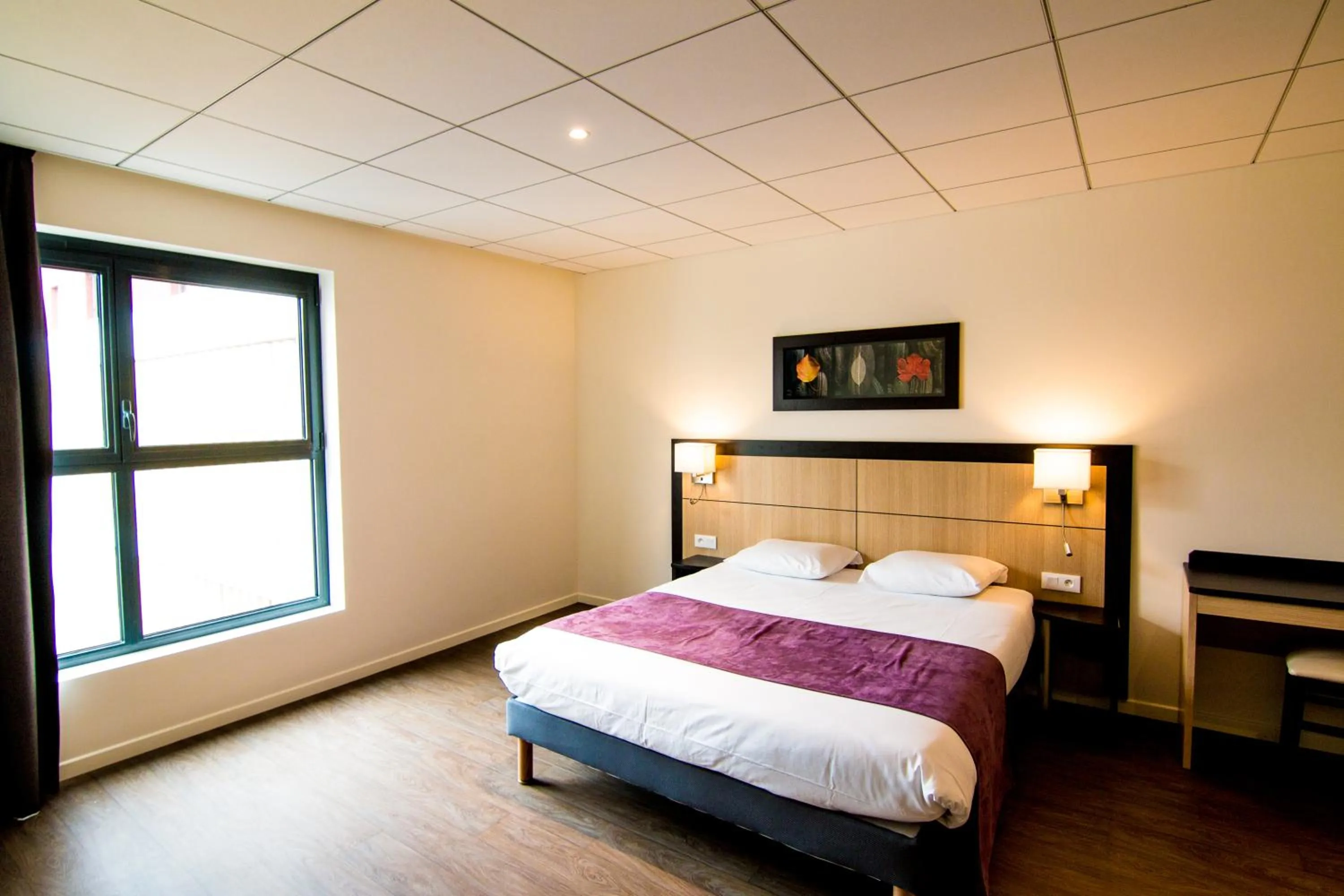 Bed in Tulip Inn Thionville Residences