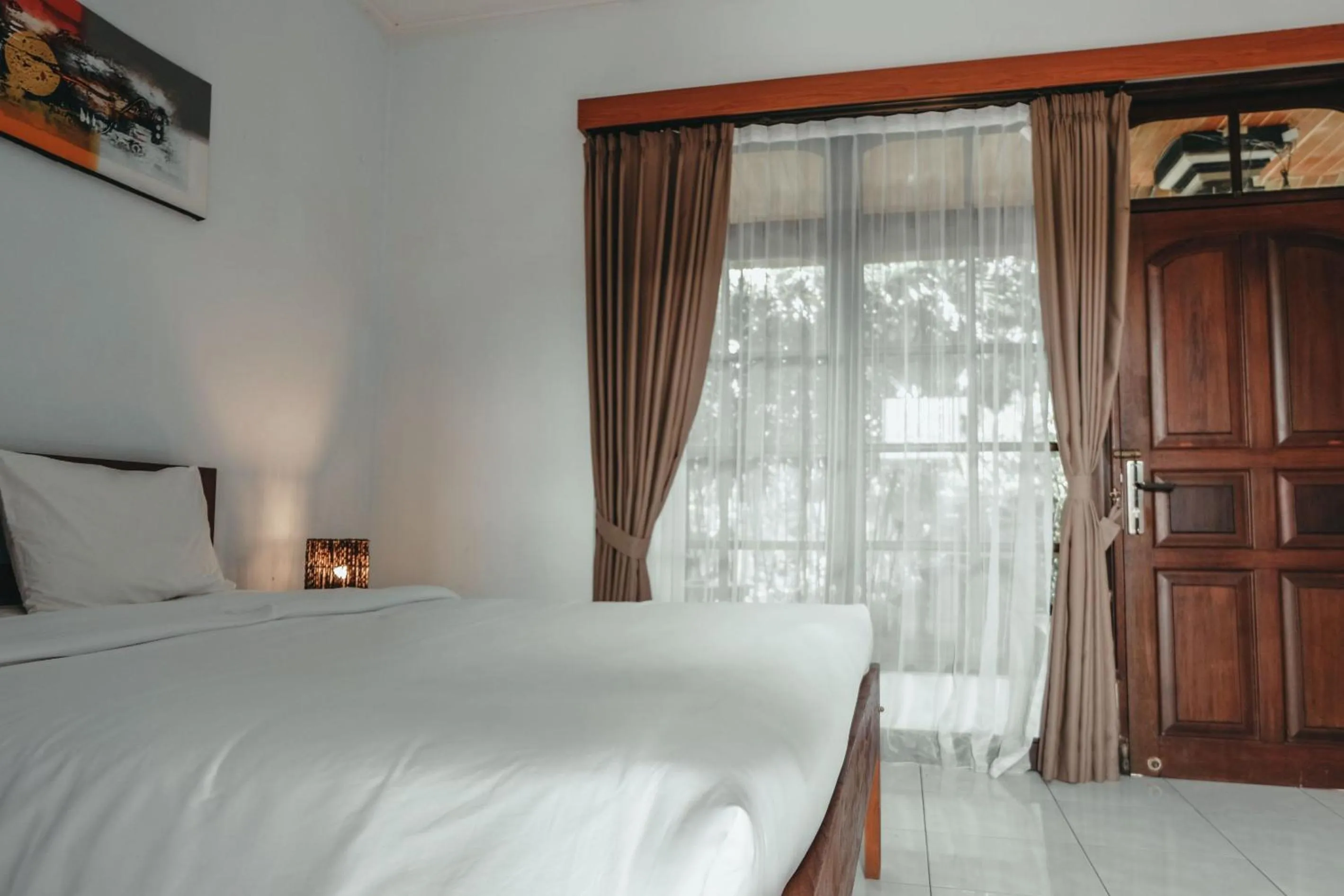 Photo of the whole room, Bed in Sekar Arum Riverside Resort in Canggu