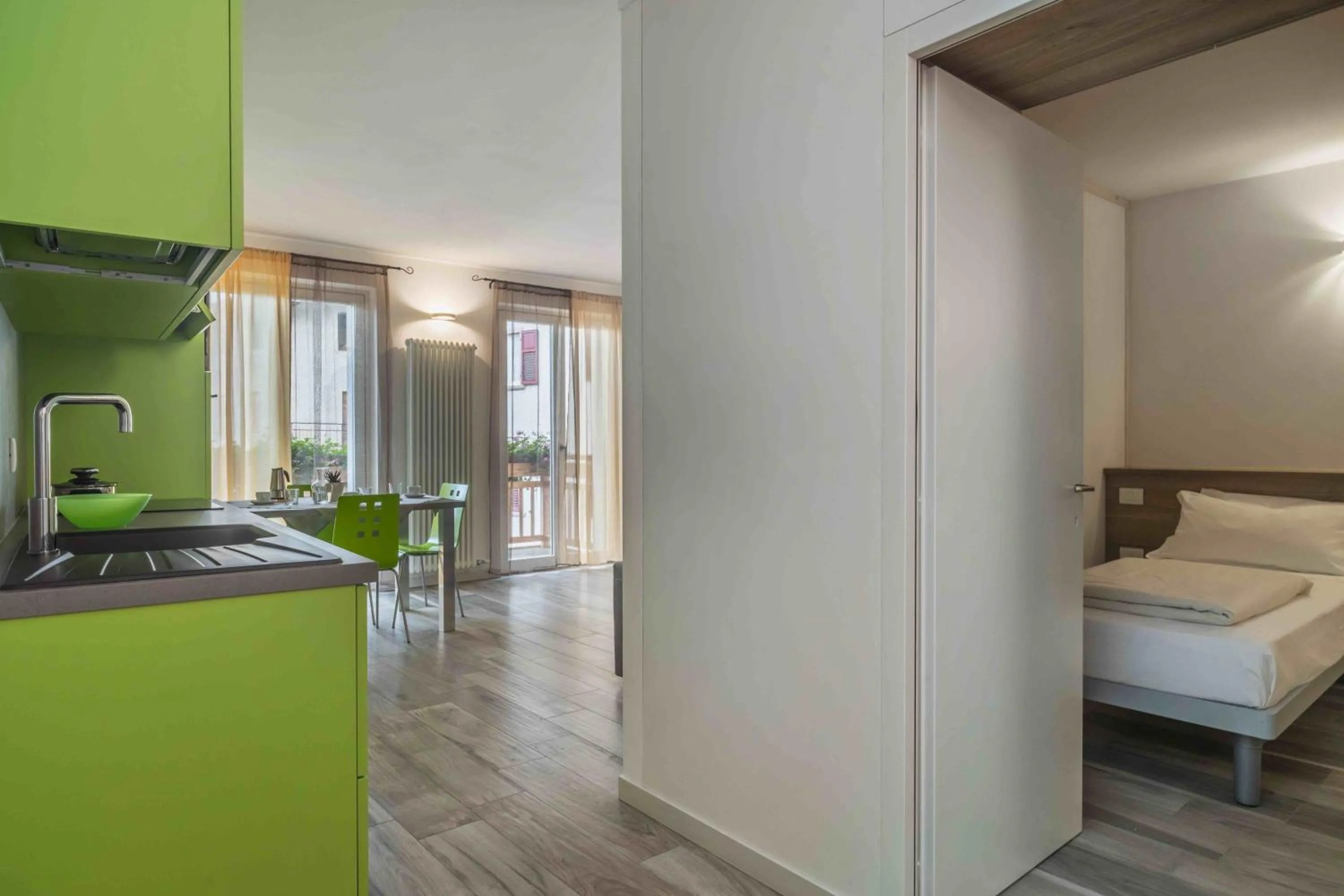 Kitchen or kitchenette, Bed in Appartamenti Decarli