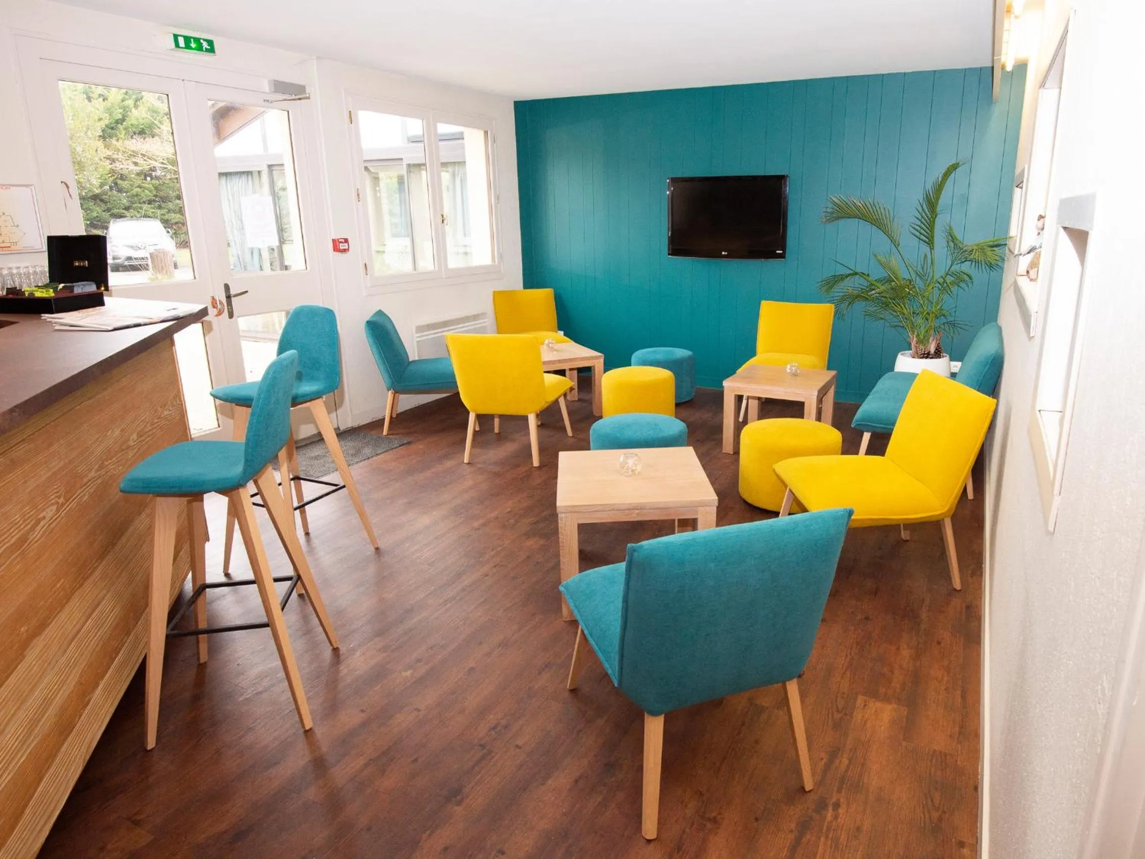 Communal lounge/ TV room in Cit'Hotel Les Eleis