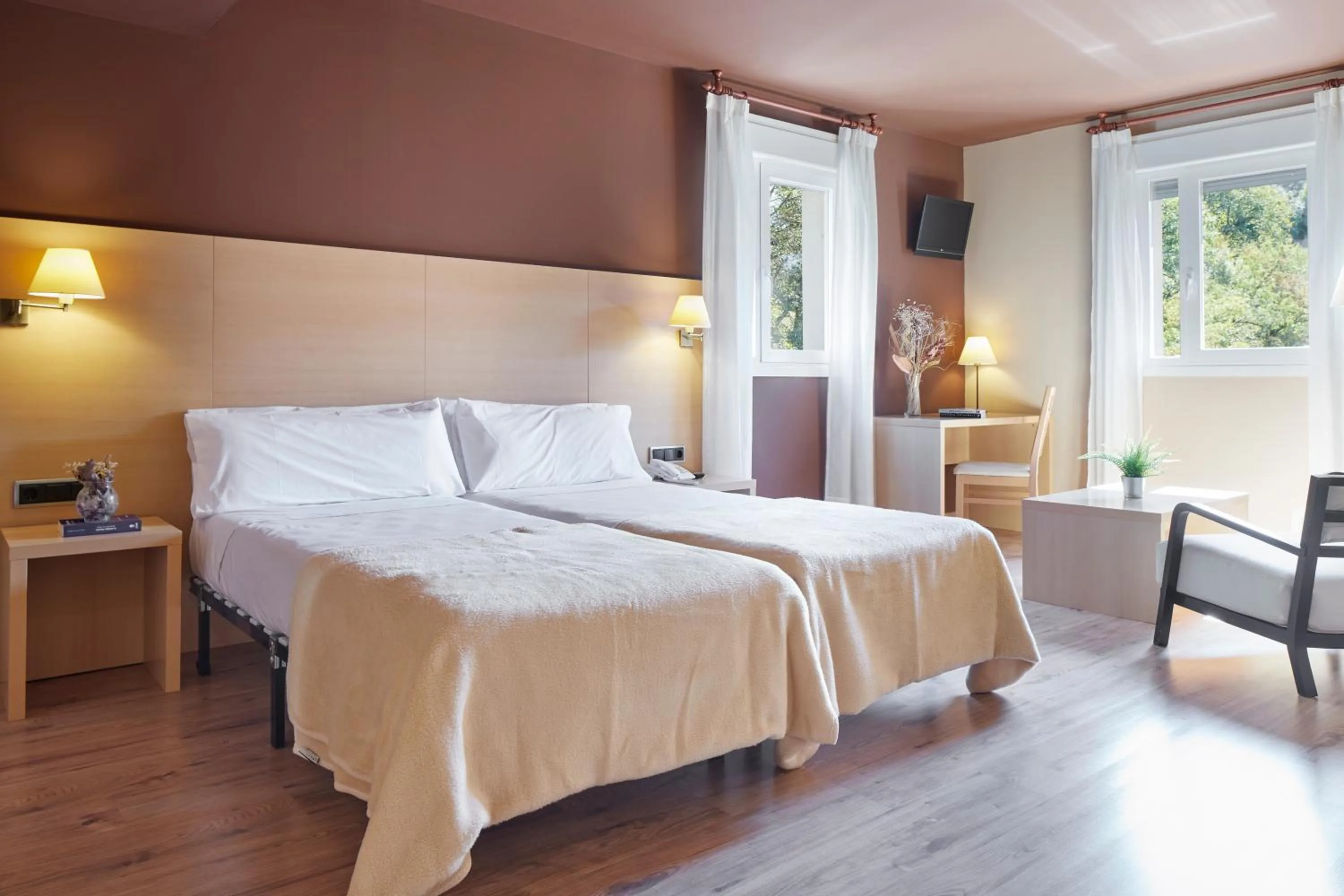 Text overlay, Bed in Iraipe Santuario de Arantzazu Hotel