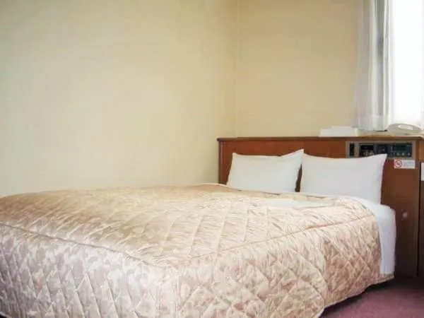 Bed in Nishishinjuku Green Hotel