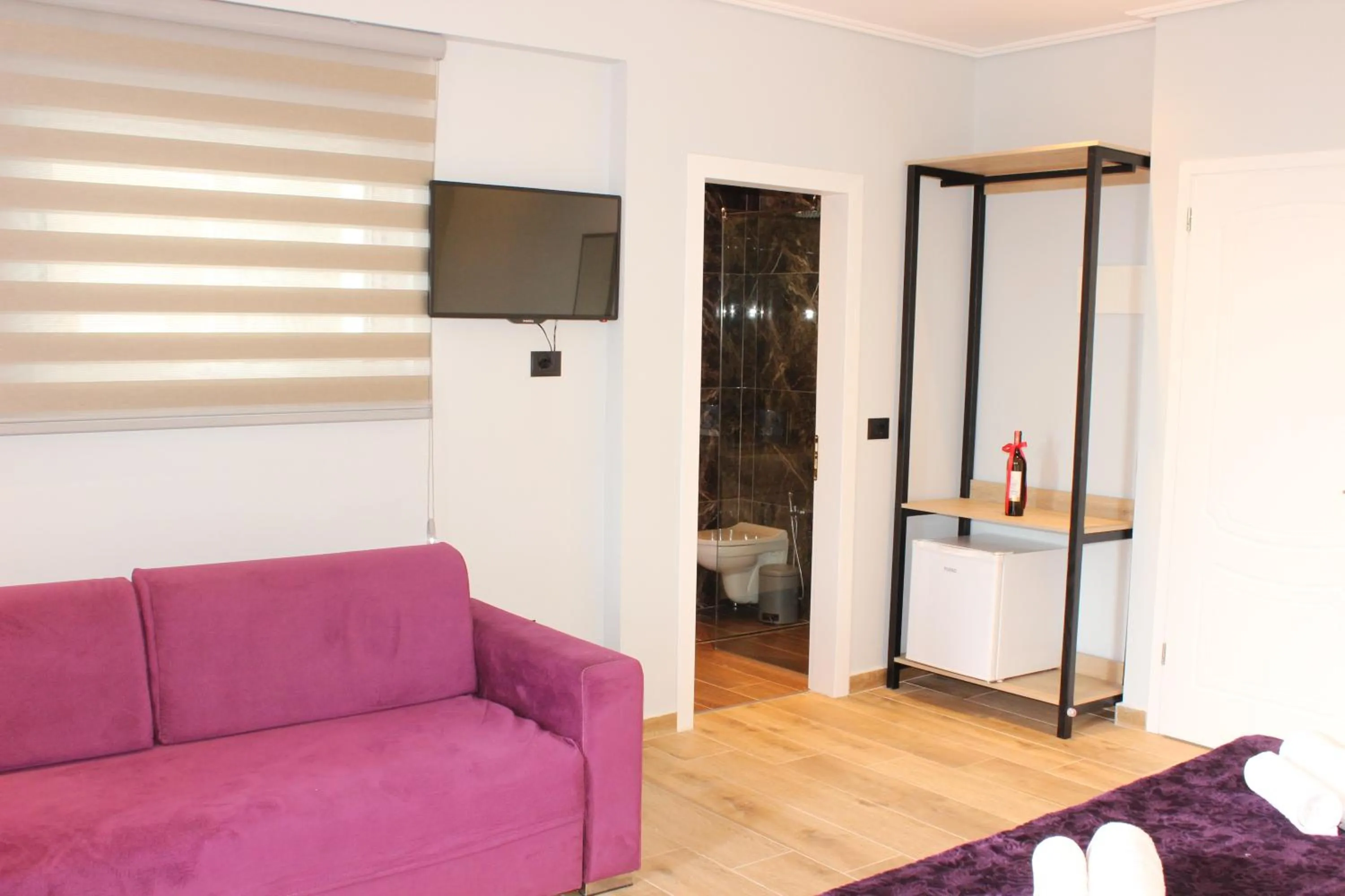 Communal lounge/ TV room in Bebi Hotel And Apartments