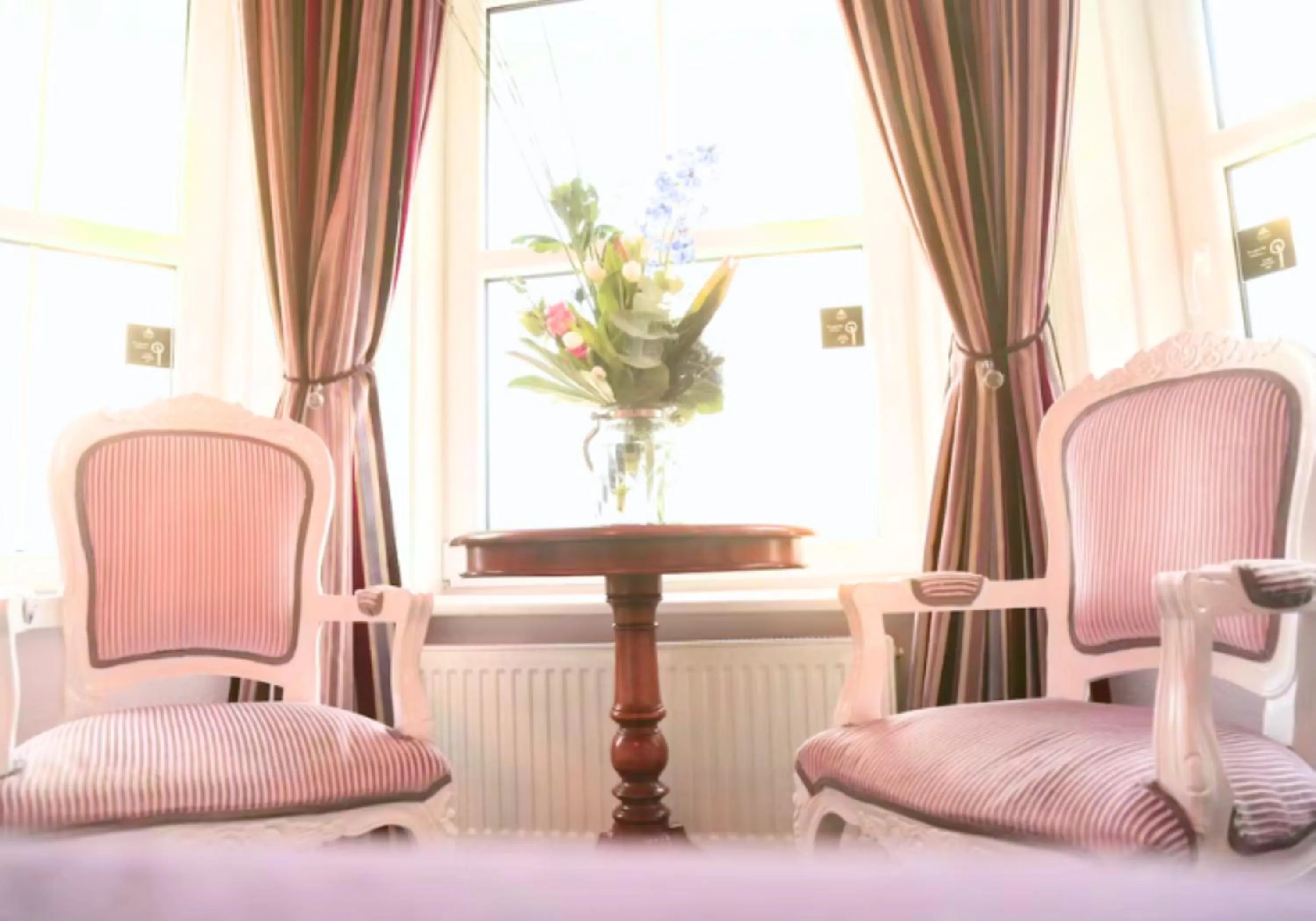Seating area, Bed in East Beach Hotel