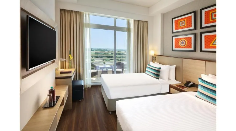 Bed in Sandal Suites by Lemon Tree Hotels