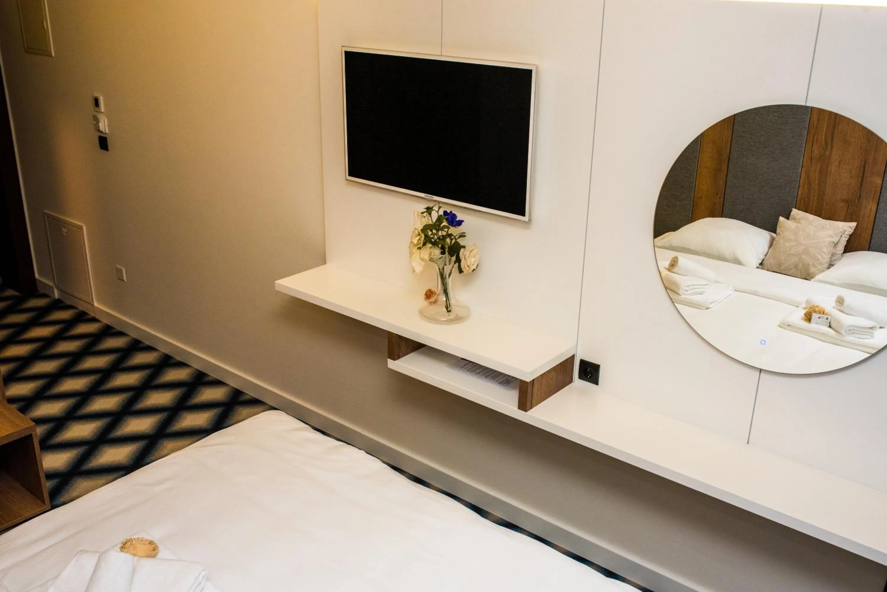 Communal lounge/ TV room, Bed in Swiss Plus Hotel