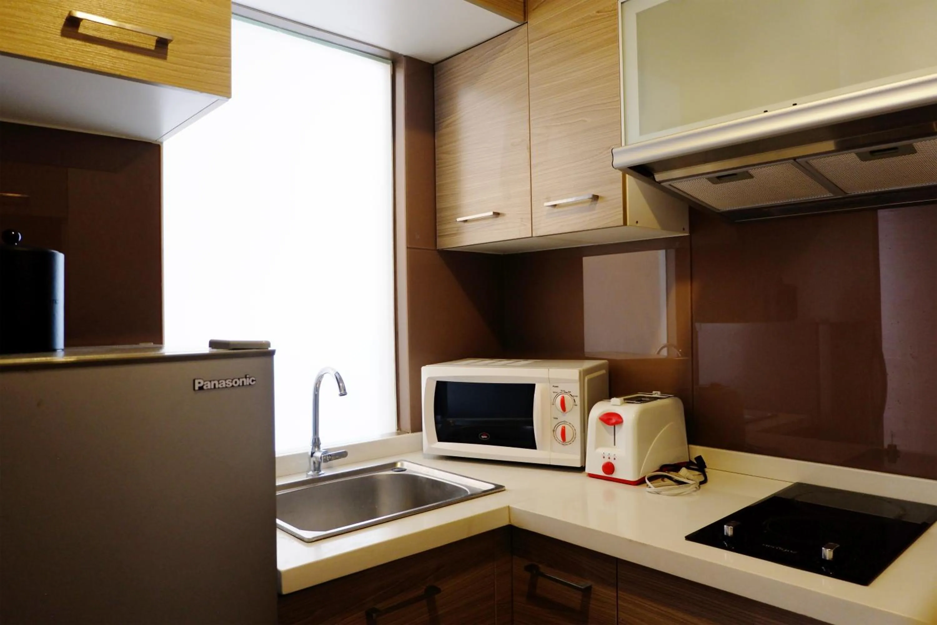 Kitchen or kitchenette in Valero Grand Suites by Swiss-Belhotel