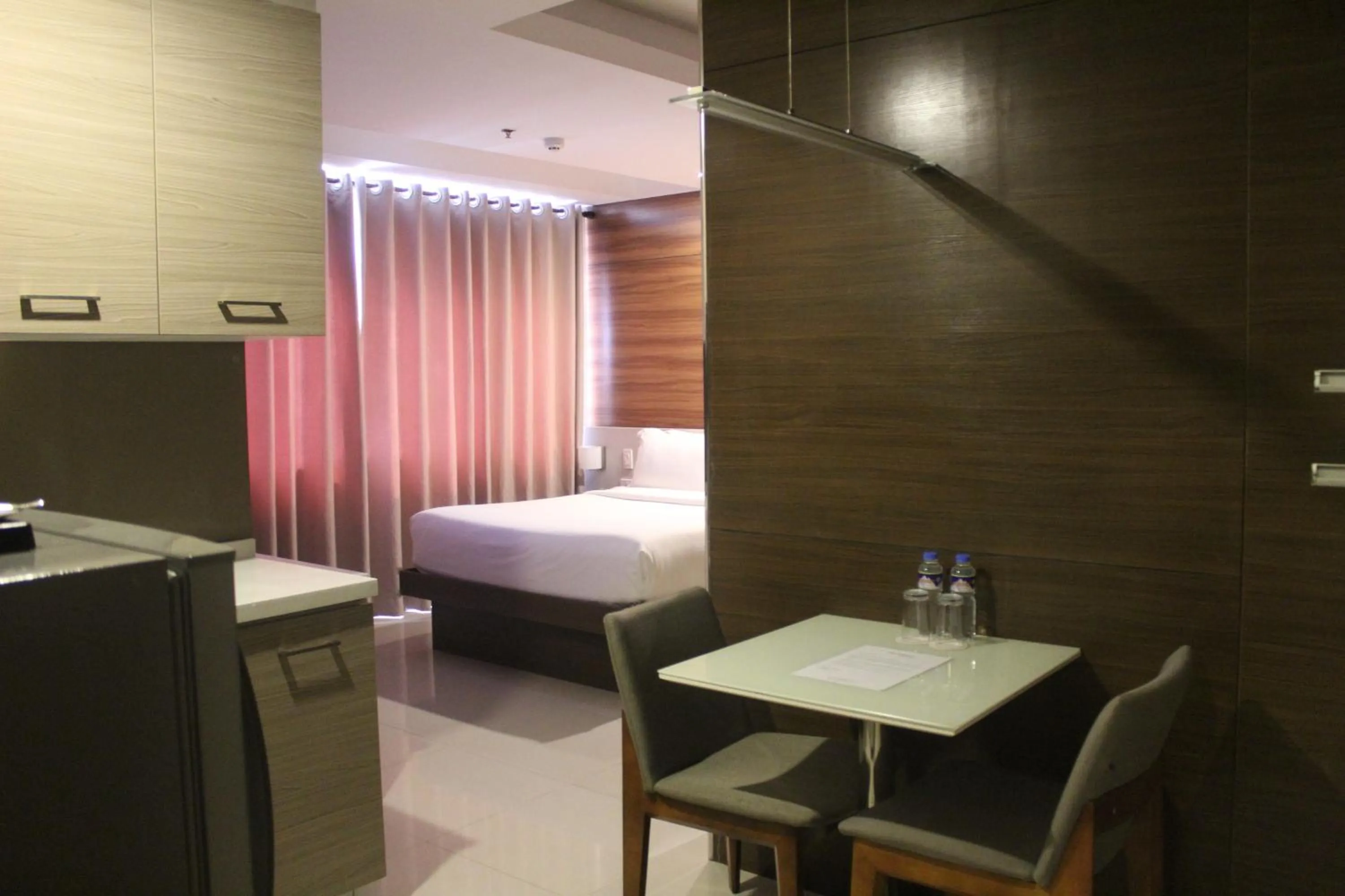 Bed in Valero Grand Suites by Swiss-Belhotel