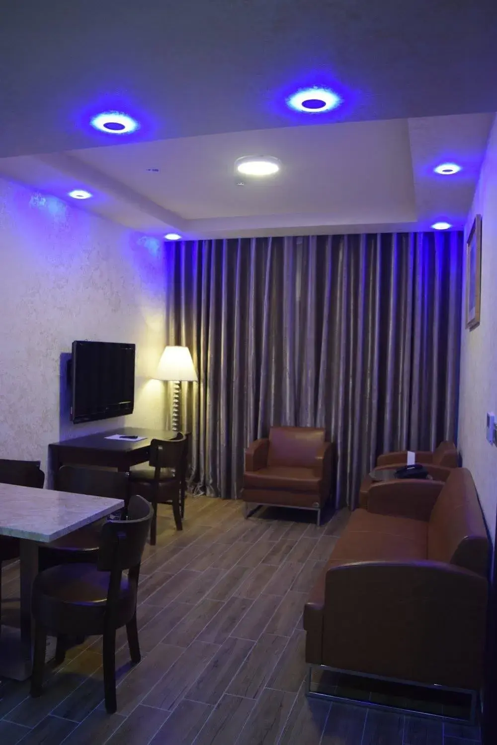 Communal lounge/ TV room, Bed in Aljamal Hotel