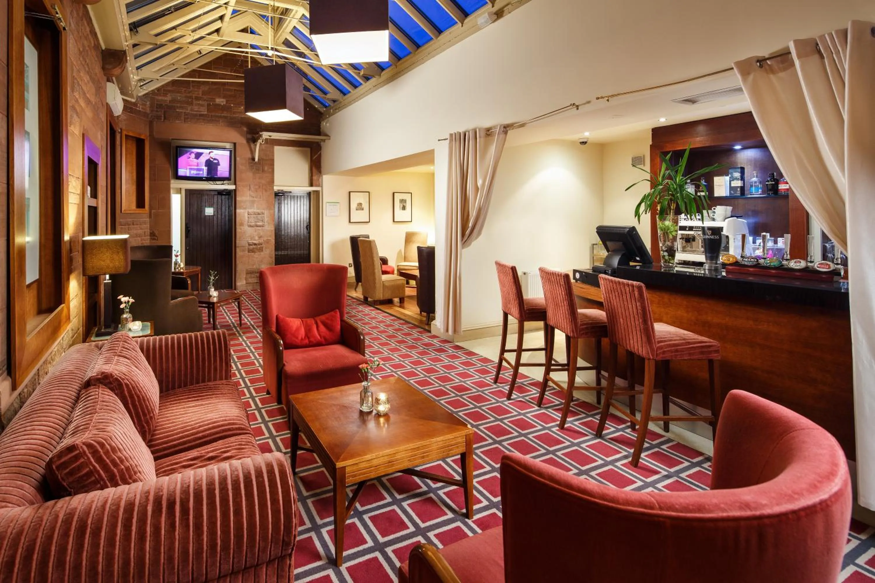 Communal lounge/ TV room in Holiday Inn Dumfries by IHG
