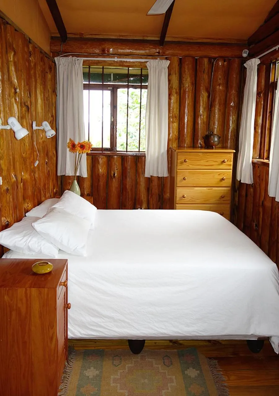 Bed in Veki's Village Cottages