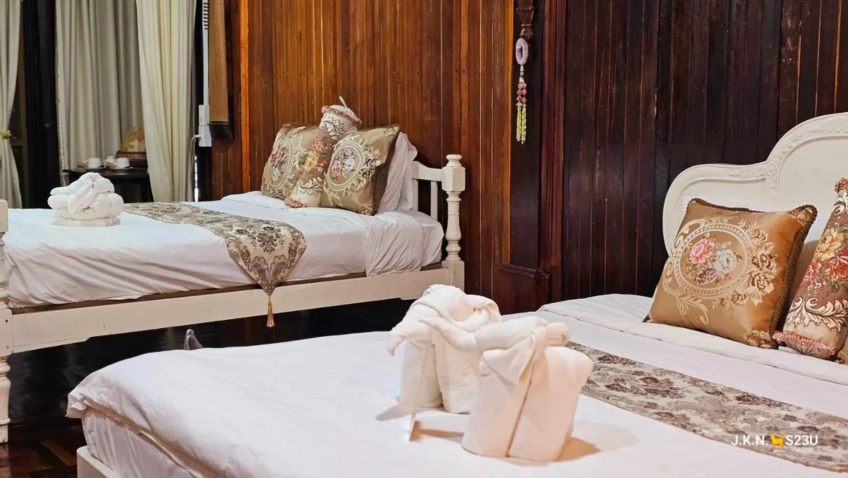 Bed in The Antique Riverside Resort