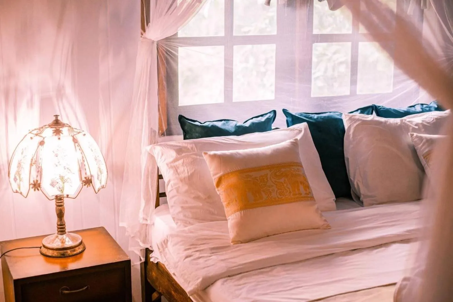 Bed in The Antique Riverside Resort