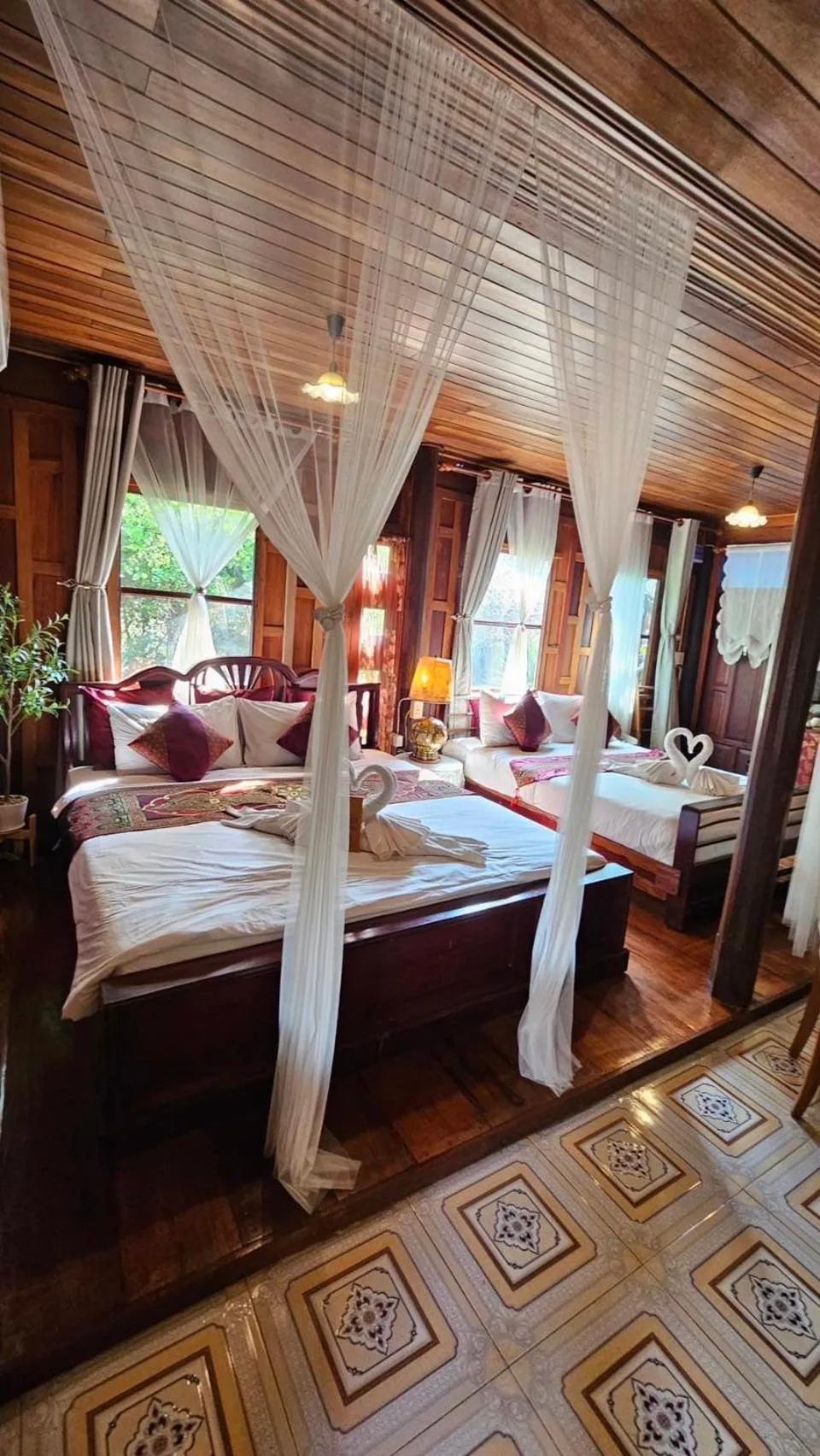 Bed in The Antique Riverside Resort
