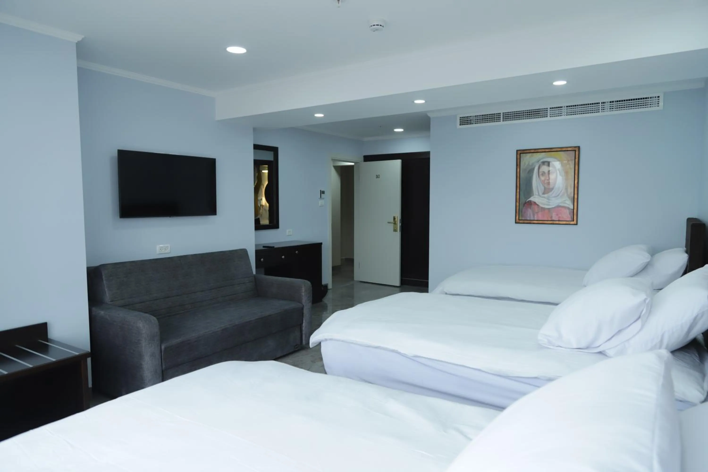 Communal lounge/ TV room, Bed in Mount of Olives Hotel