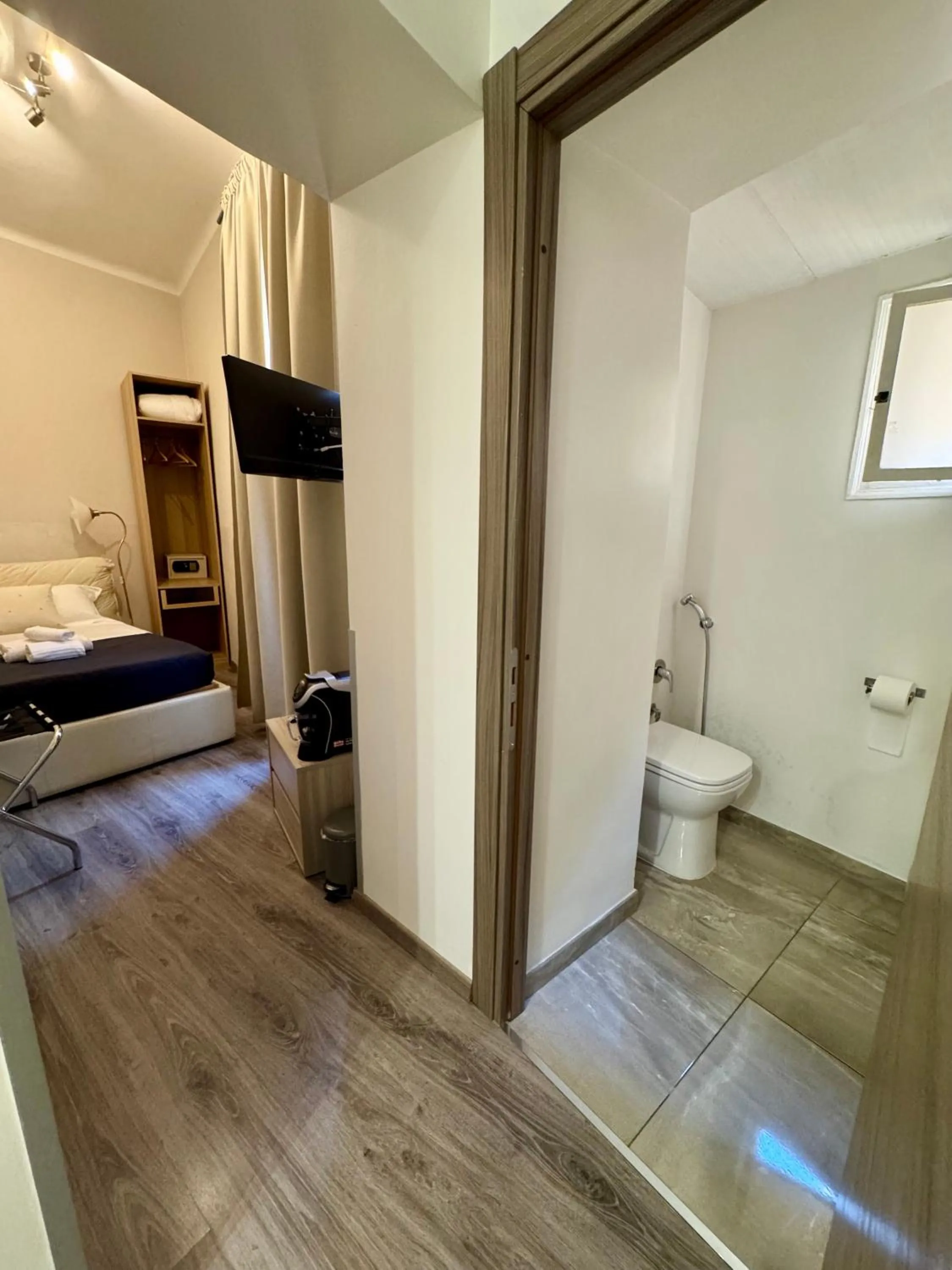 Photo of the whole room, Bed in RHS Rienzo Suites