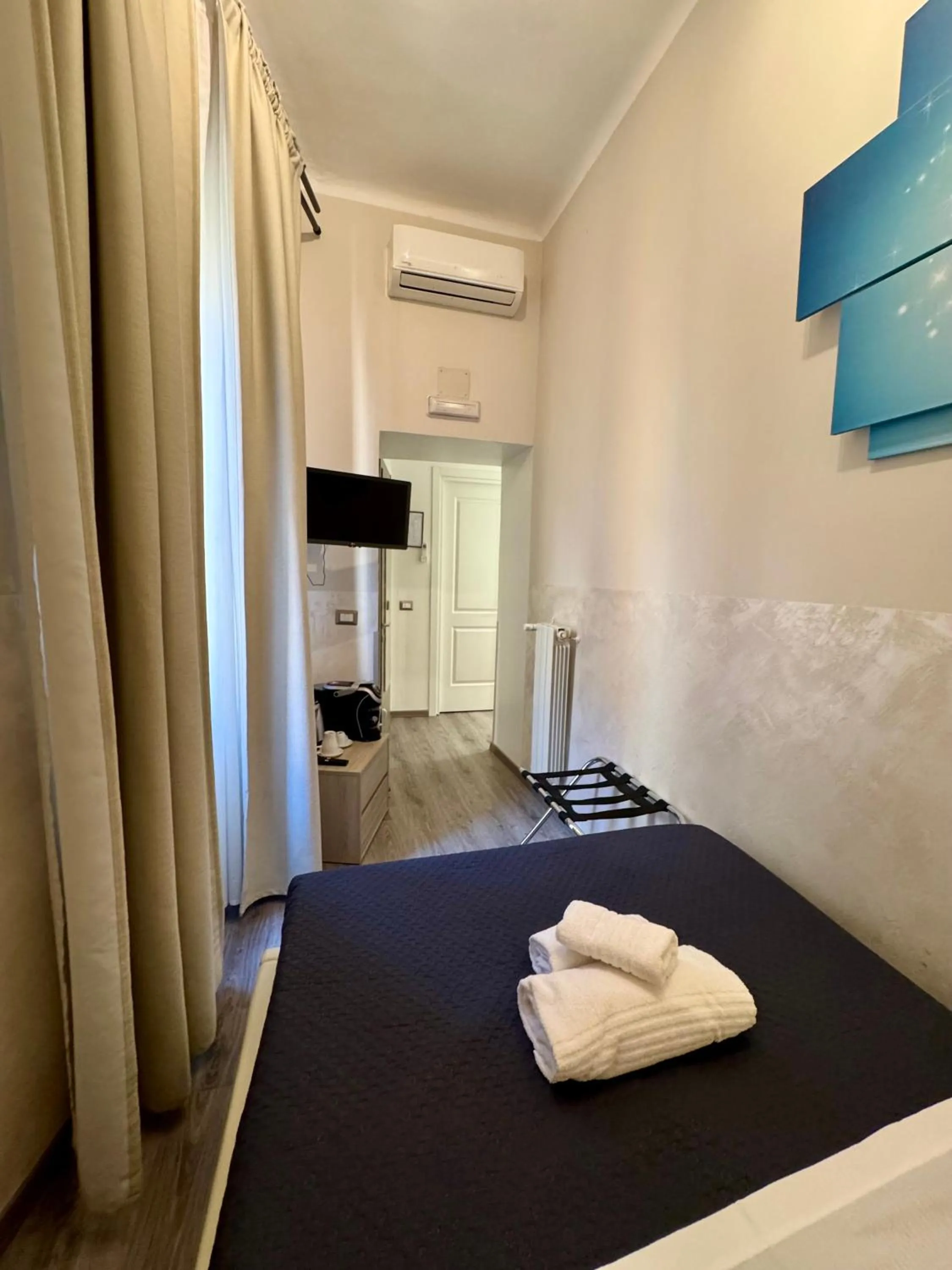 Photo of the whole room, Bed in RHS Rienzo Suites