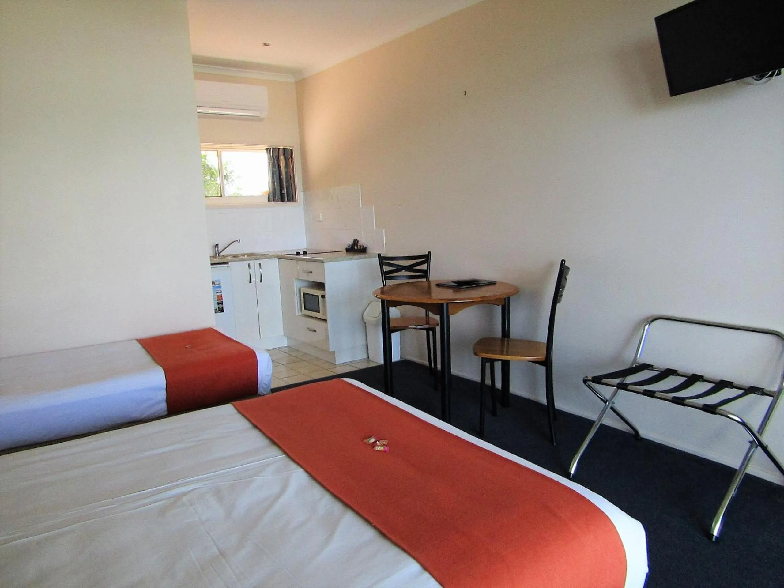 Bed in Sunlit Waters Studio Apartments