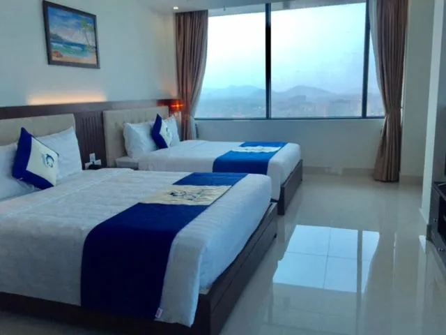 Bed in Blue Wave Hotel