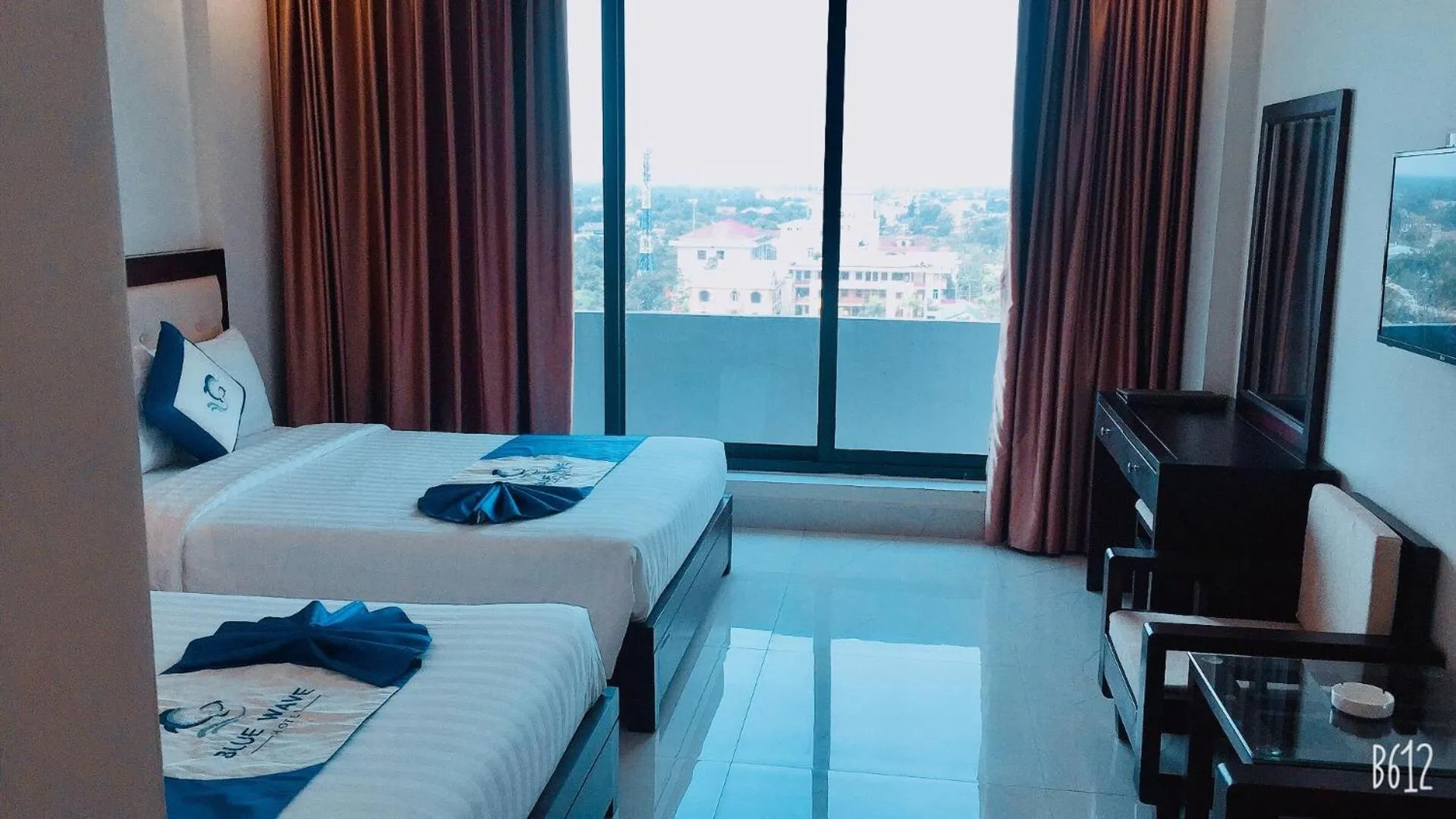 Bed in Blue Wave Hotel